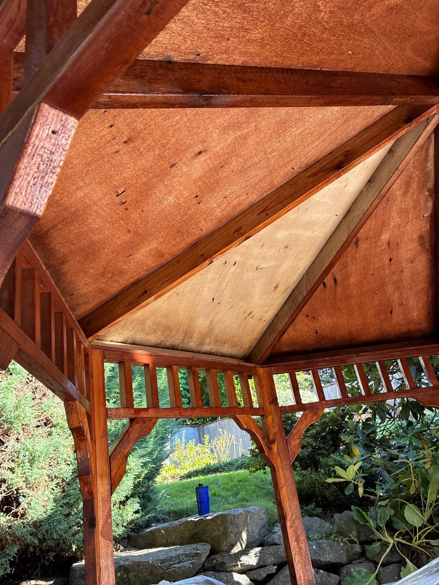 Gazebo ceiling and rafters cleaned and sealed with rich warm protective tone