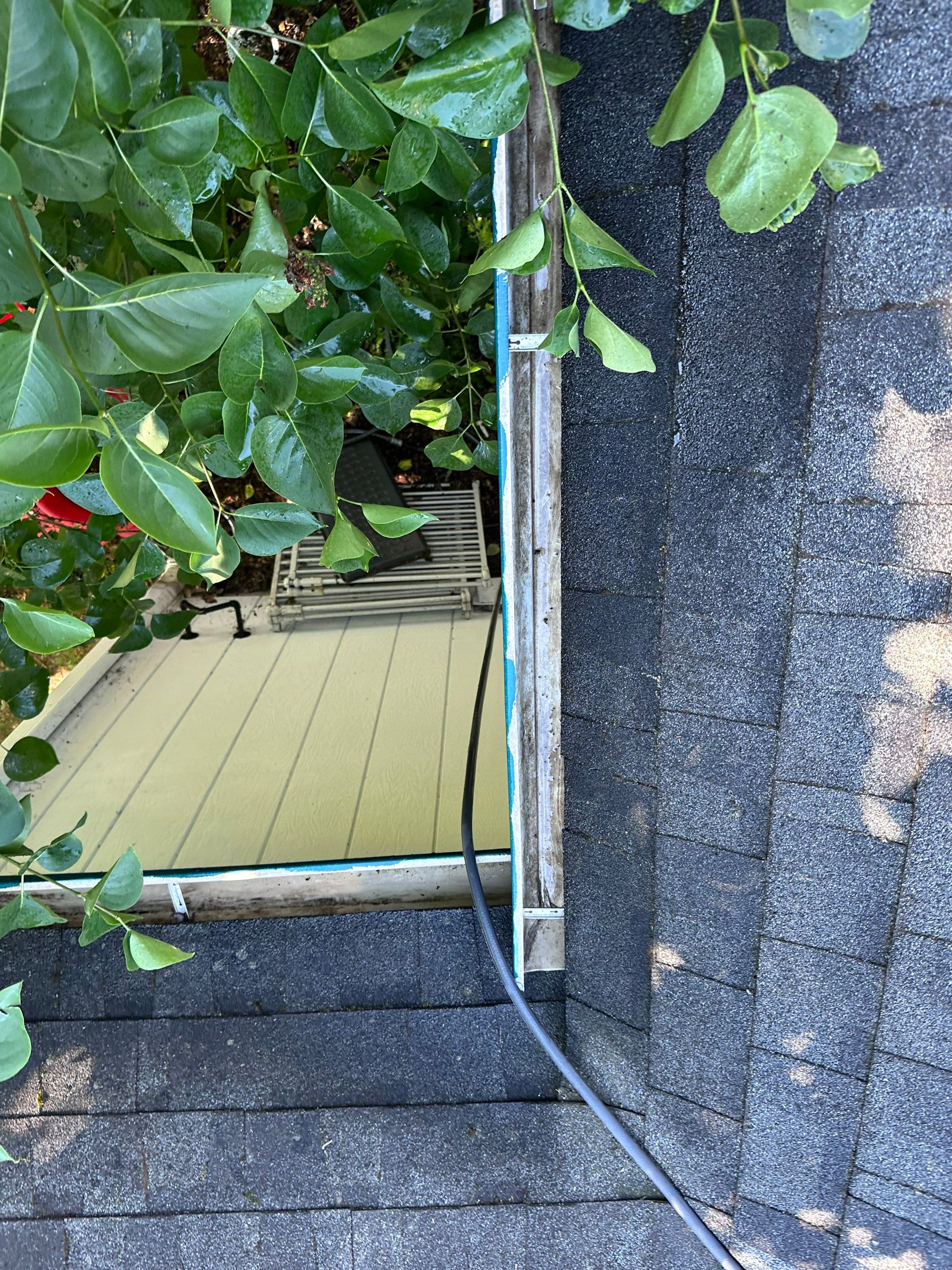 Cleaned gutter channel — completely flushed, clean trough with unobstructed drainage away from roof and siding