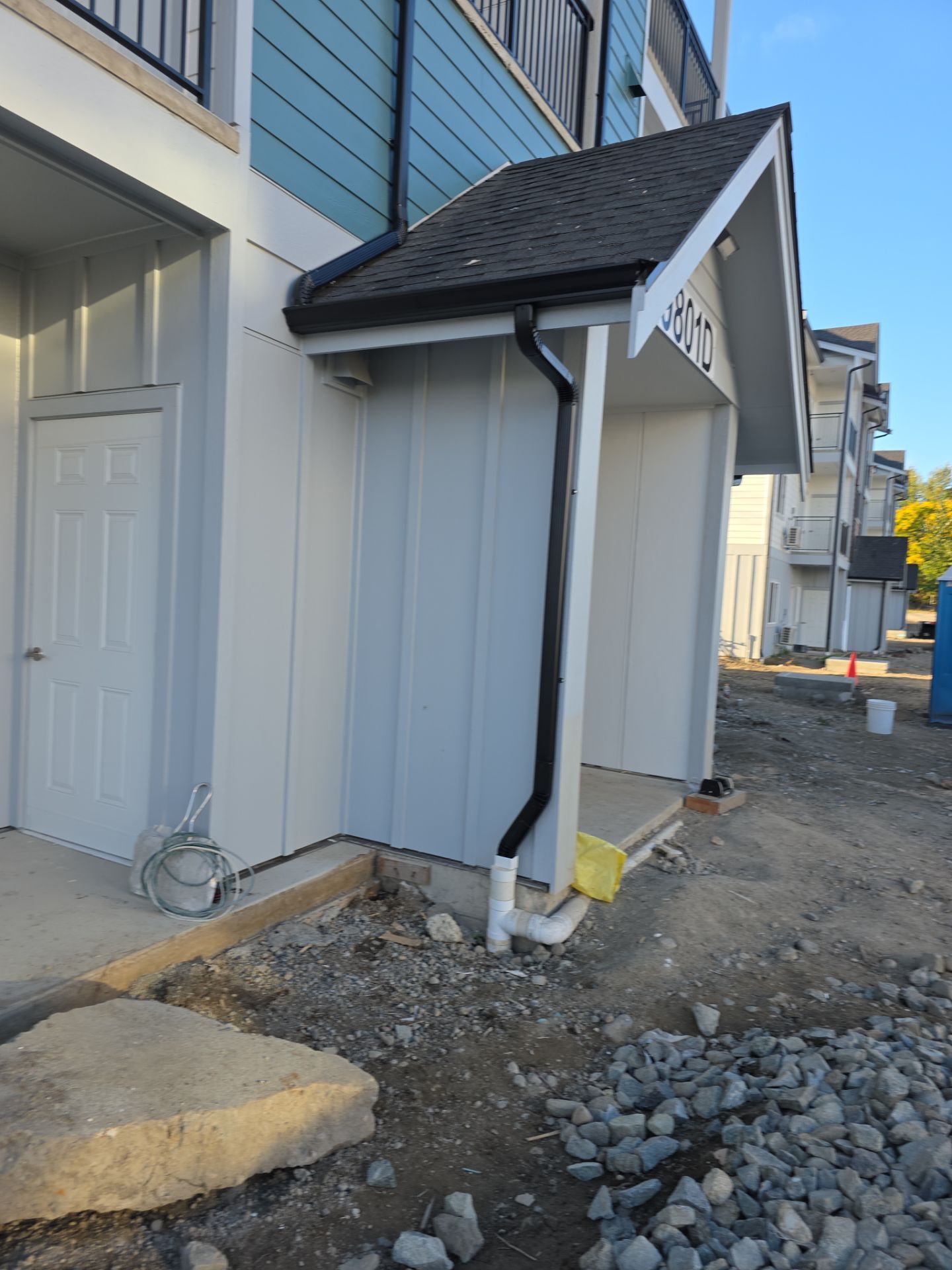 Installed seamless gutters with downspout and underground drainage tie-in