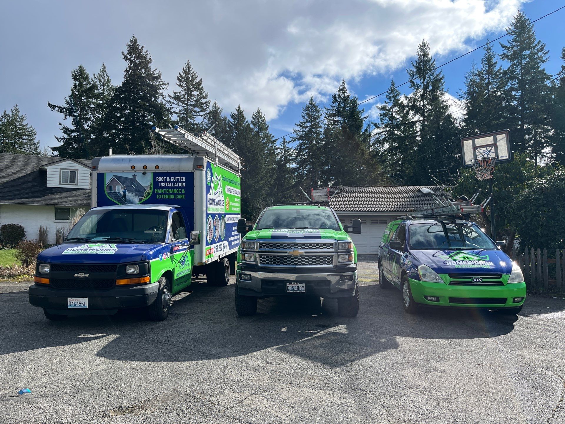 Homeworks Restoration official fleet of roof and gutter installation trucks in Puget Sound