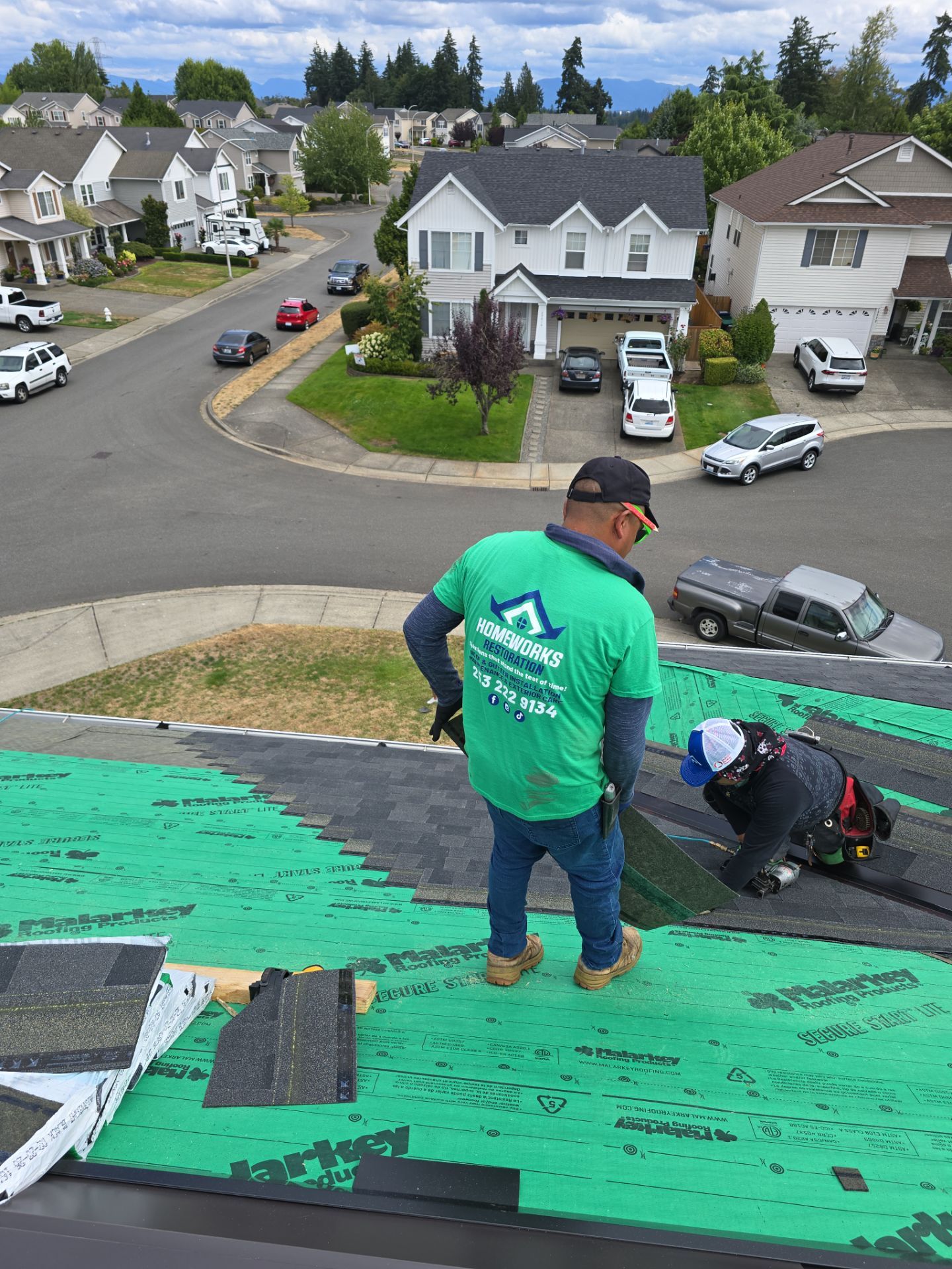 Homeworks Restoration crew installing roofing underlayment and shingles