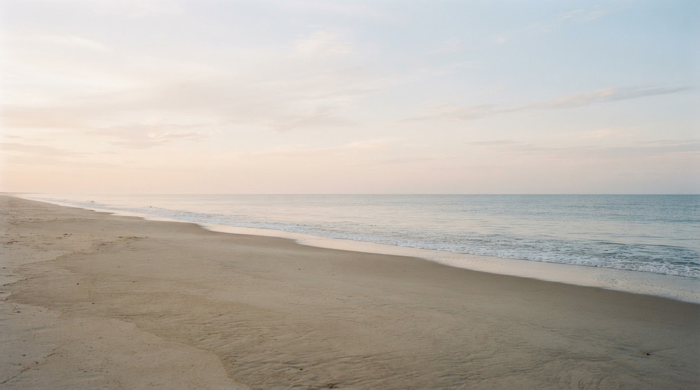 A calm expansive coastal horizon at soft morning light