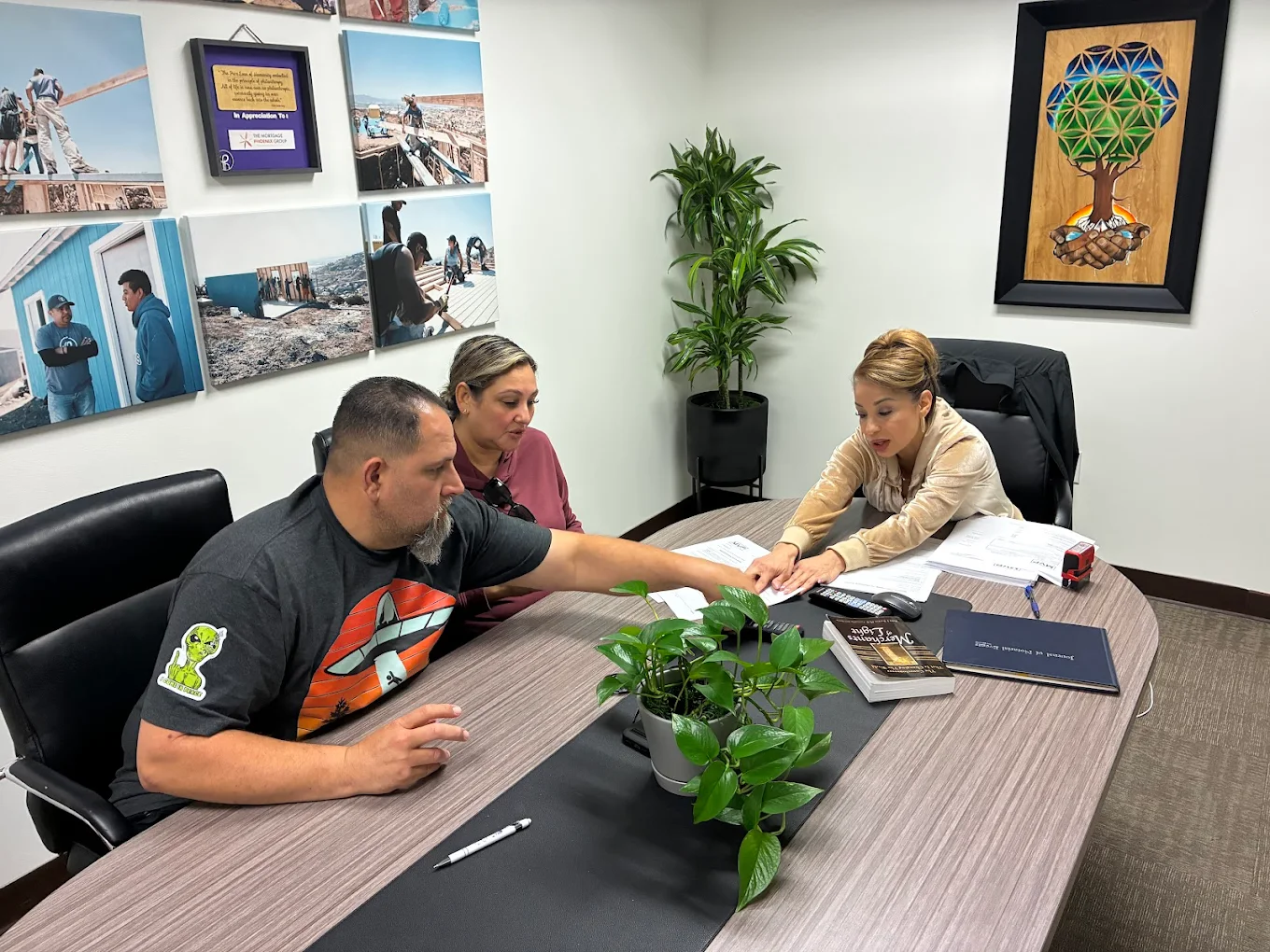 Elizabeth De Rosa, NNA-certified mobile notary signing agent, conducting a loan signing with clients at the conference table