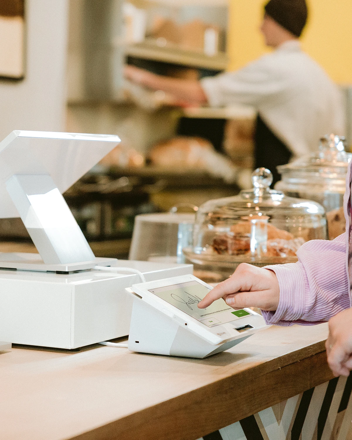 Customer completing a transaction at a Clover Station Duo countertop
