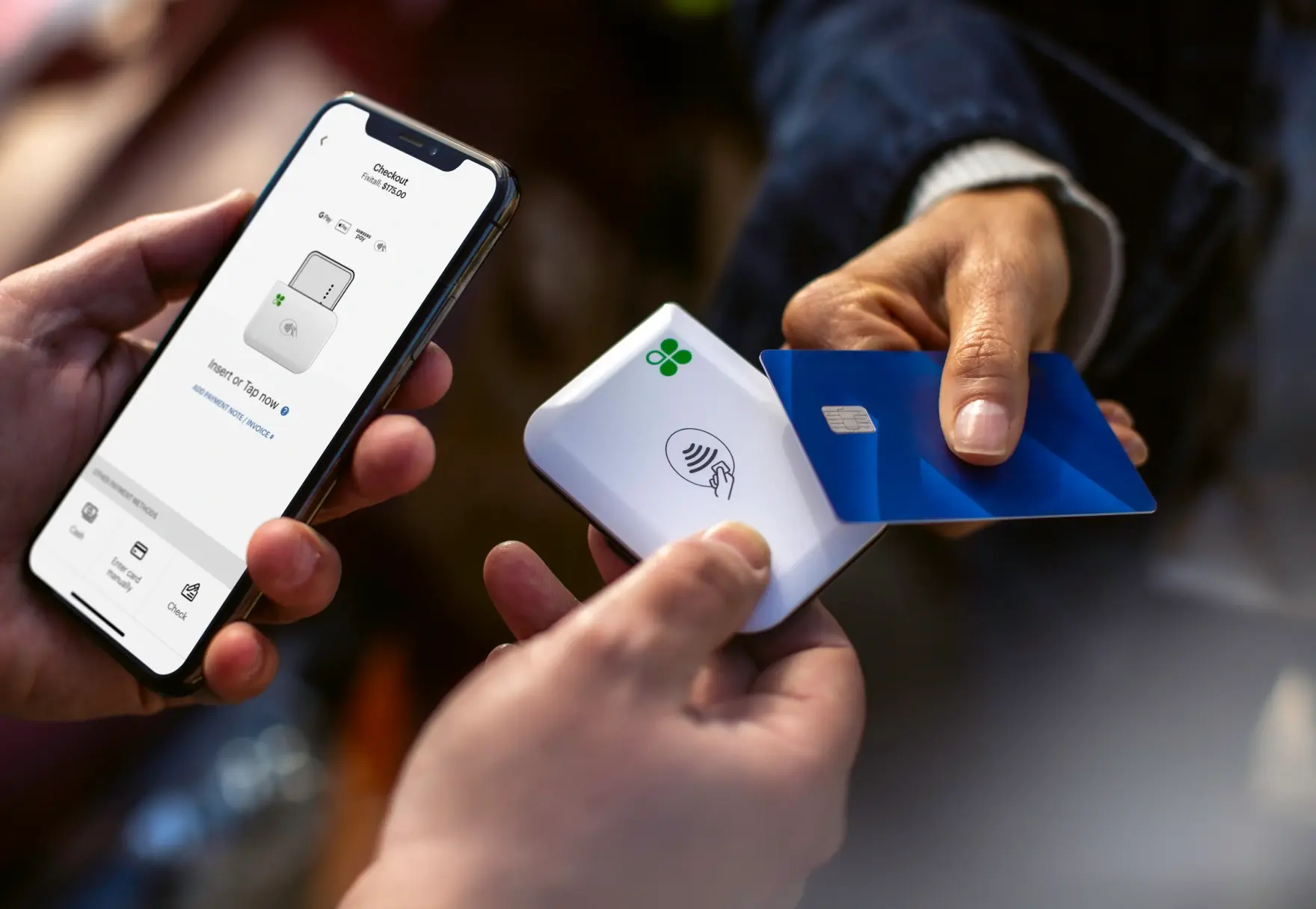Customer paying with Clover Go card reader and smartphone