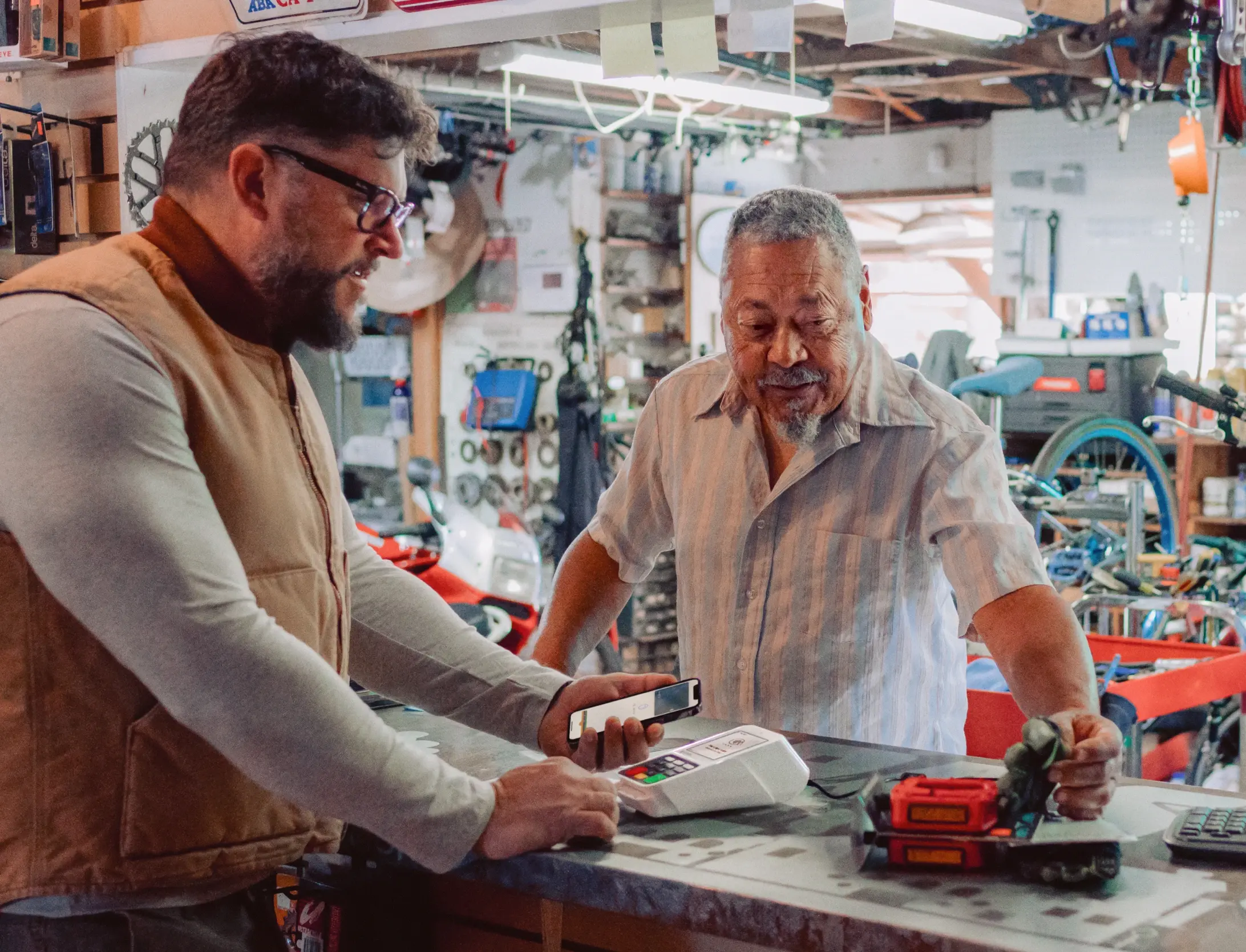 Merchant and customer completing contactless payment with Clover Compact