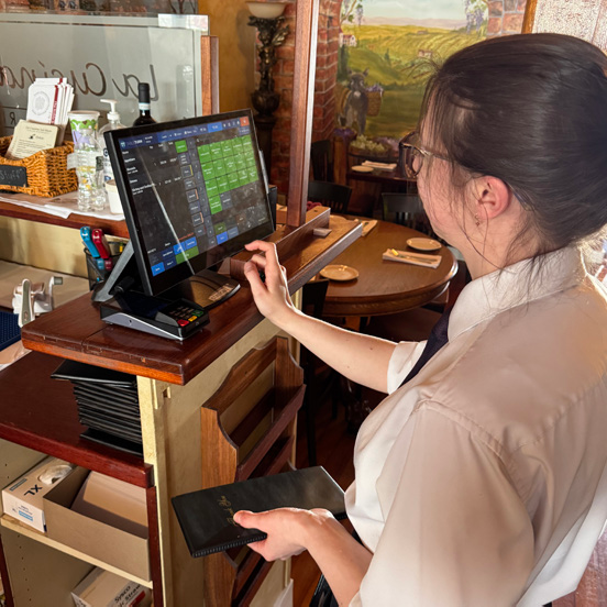 La Cucina server operating TableTurn POS terminal during dinner service