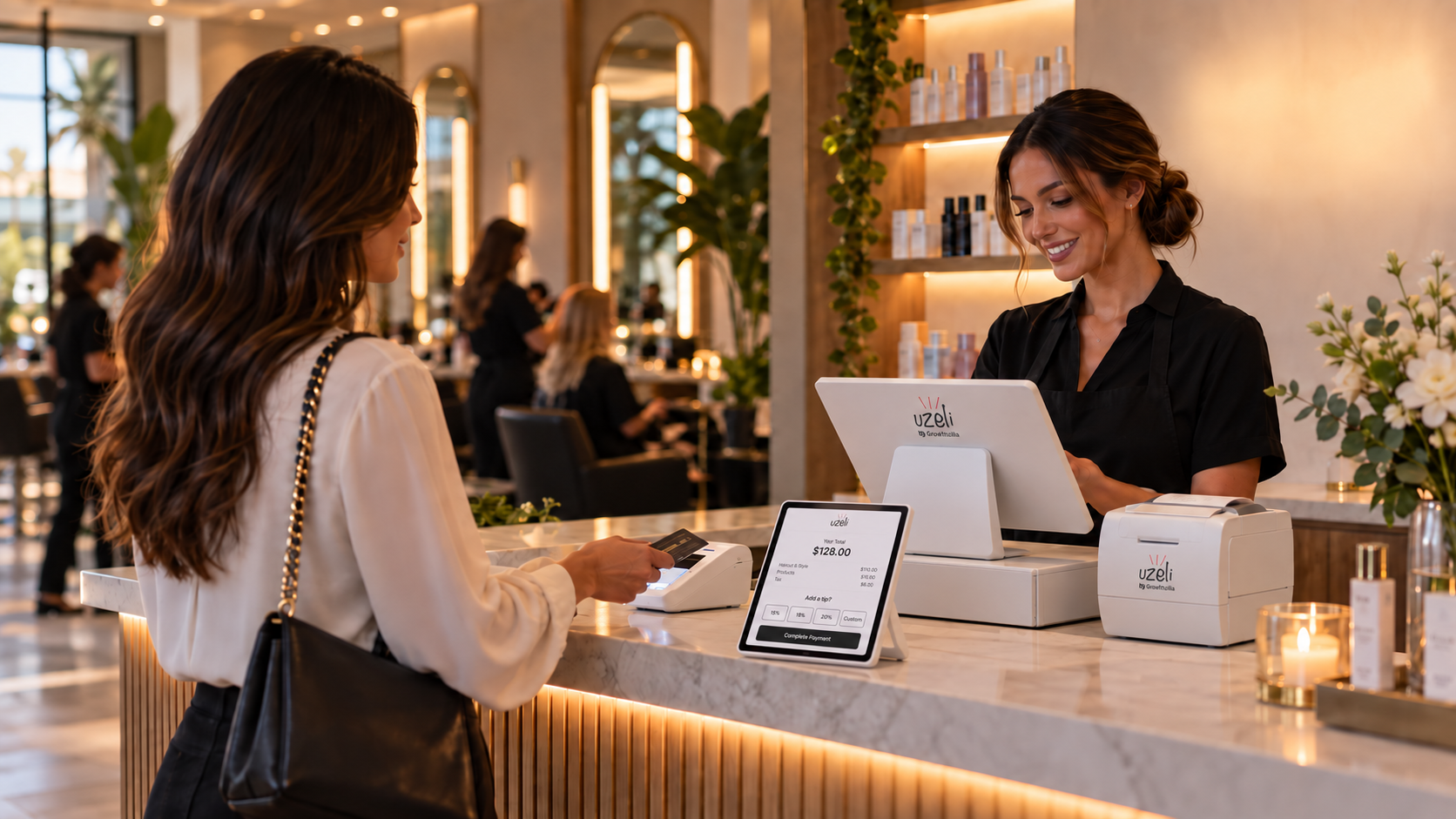 Salon client completing card payment at modern salon checkout station with receptionist