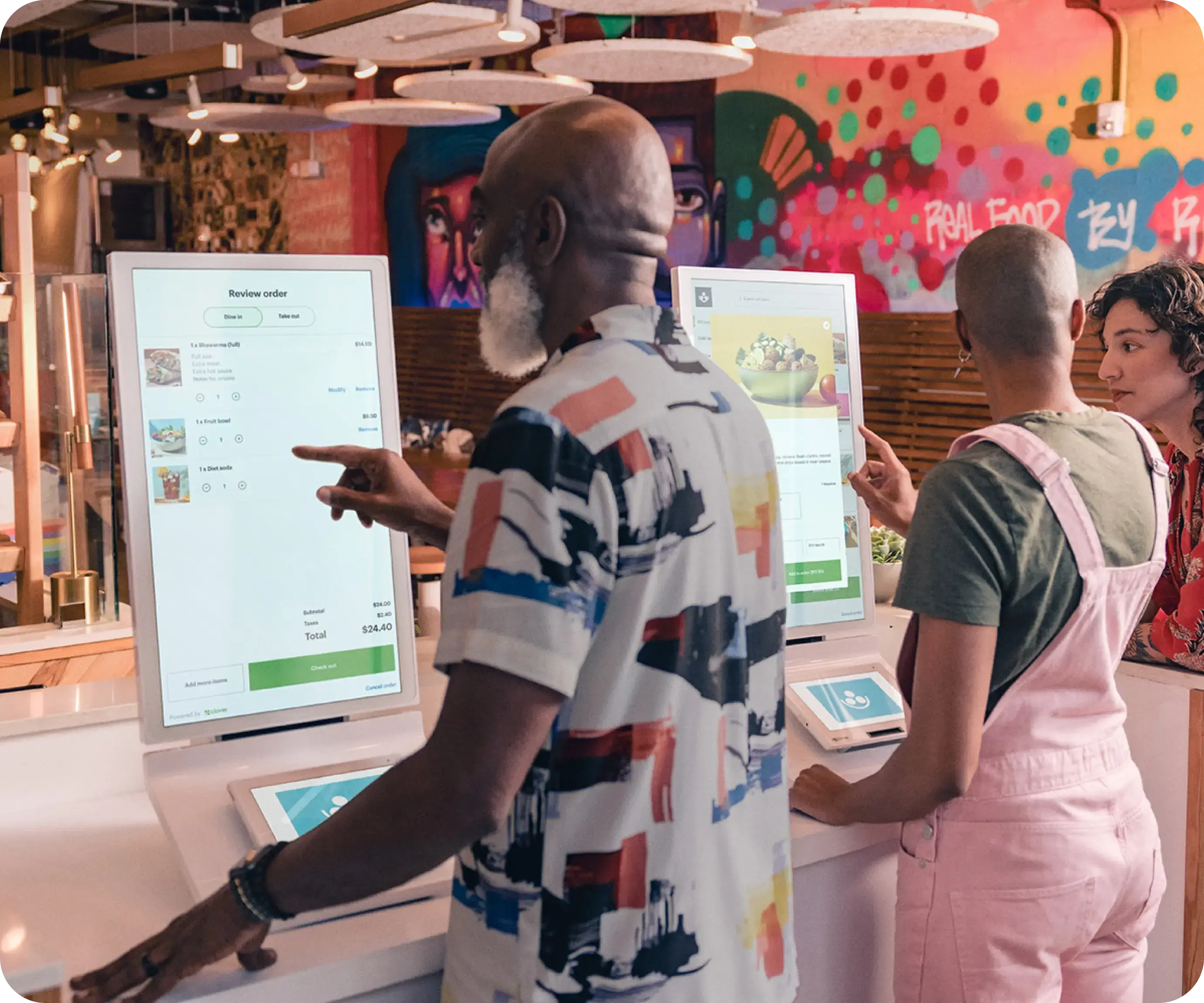 Customers using Clover Kiosk in a restaurant