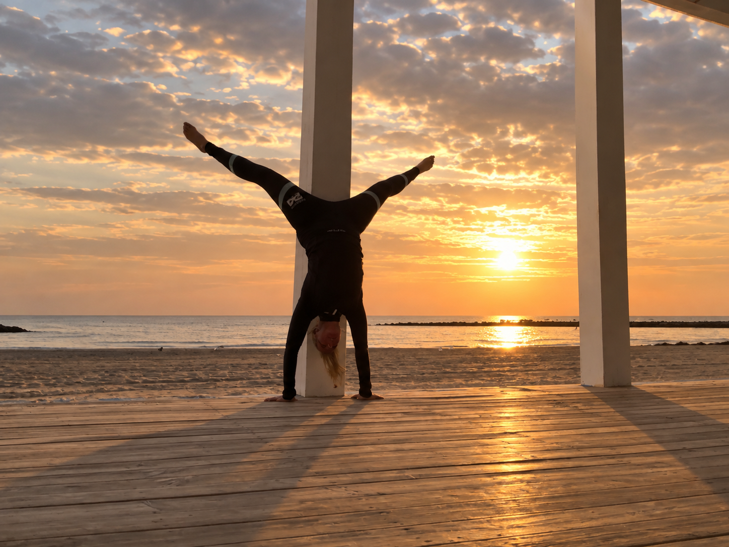 Jennifer Beck beim Handstand am Meer