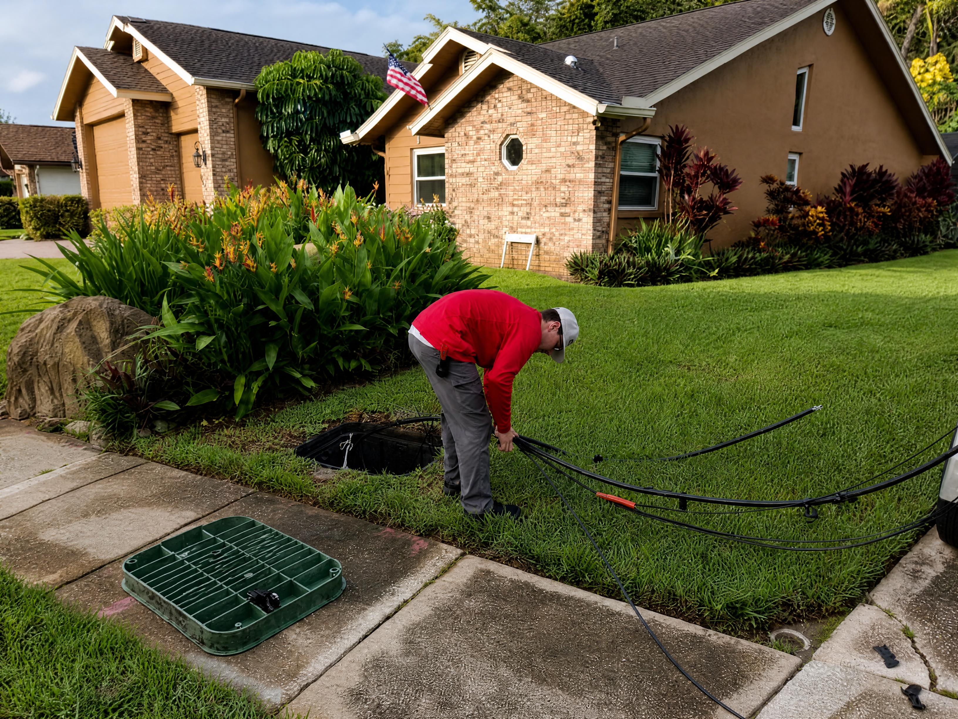 FAFO technician working at underground fiber vault and handhole on Florida utility easement