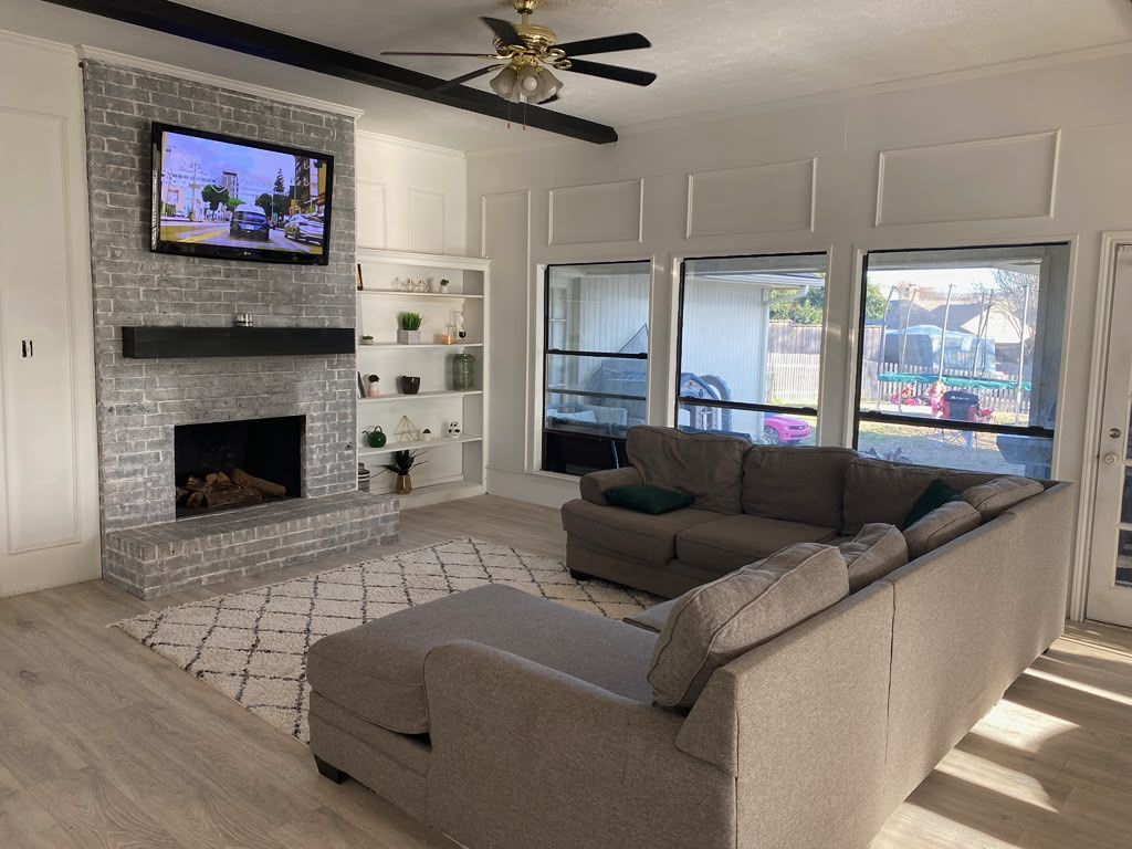 Living room and brick fireplace remodeling craftsmanship by Lakeside Roofing & Restoration in Rockwall Texas