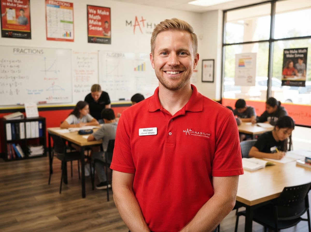 Blond male education and tutoring center director in a red Mathnasium shirt