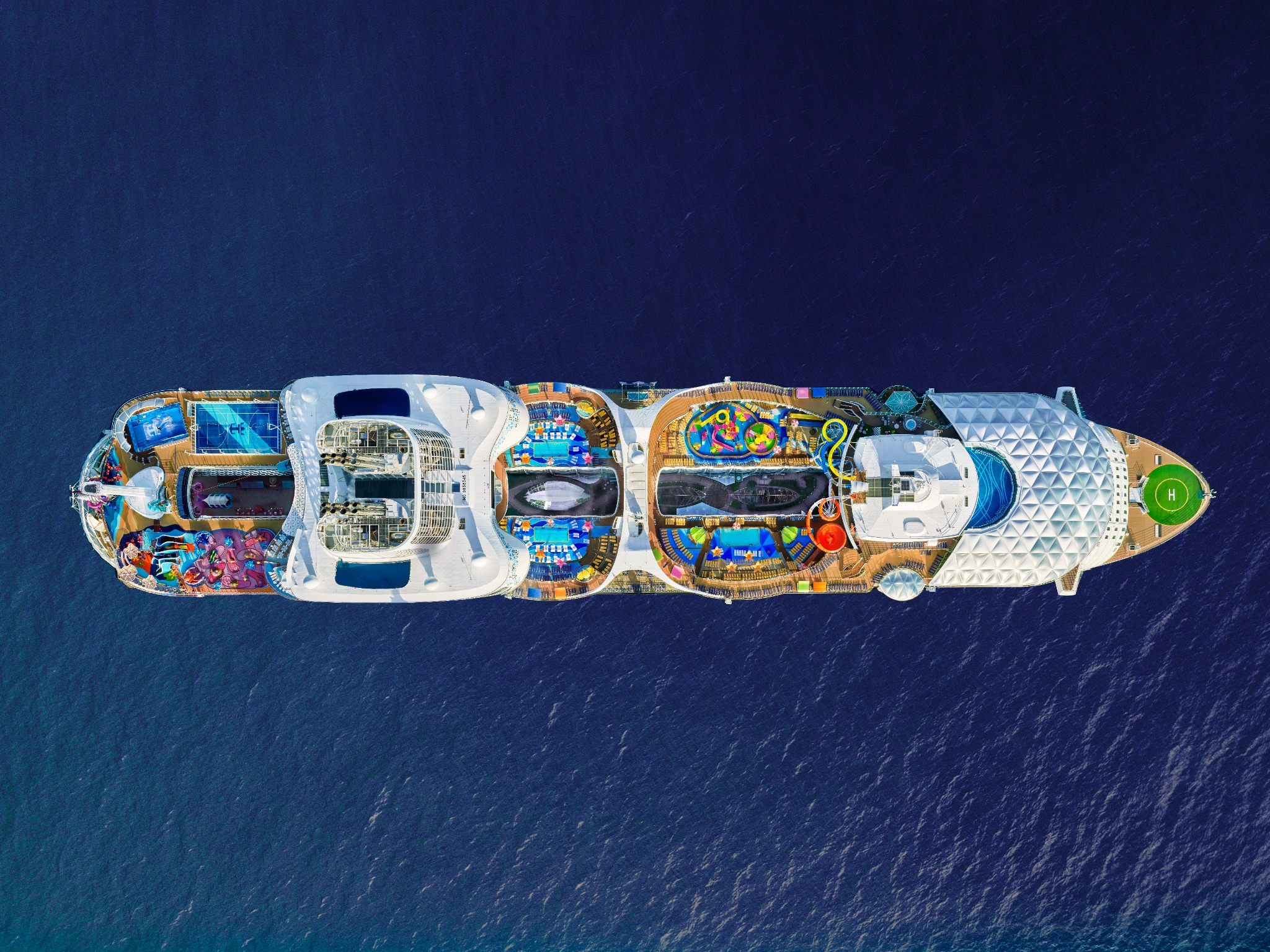 Wonder of the Seas top-deck aerial view in deep turquoise ocean waters