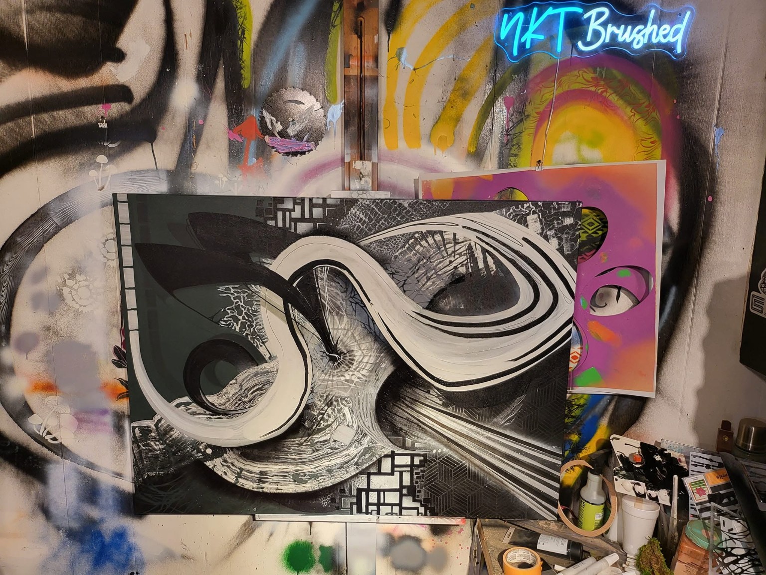 Black and white abstract canvas with dynamic swirling strokes and detailed line work