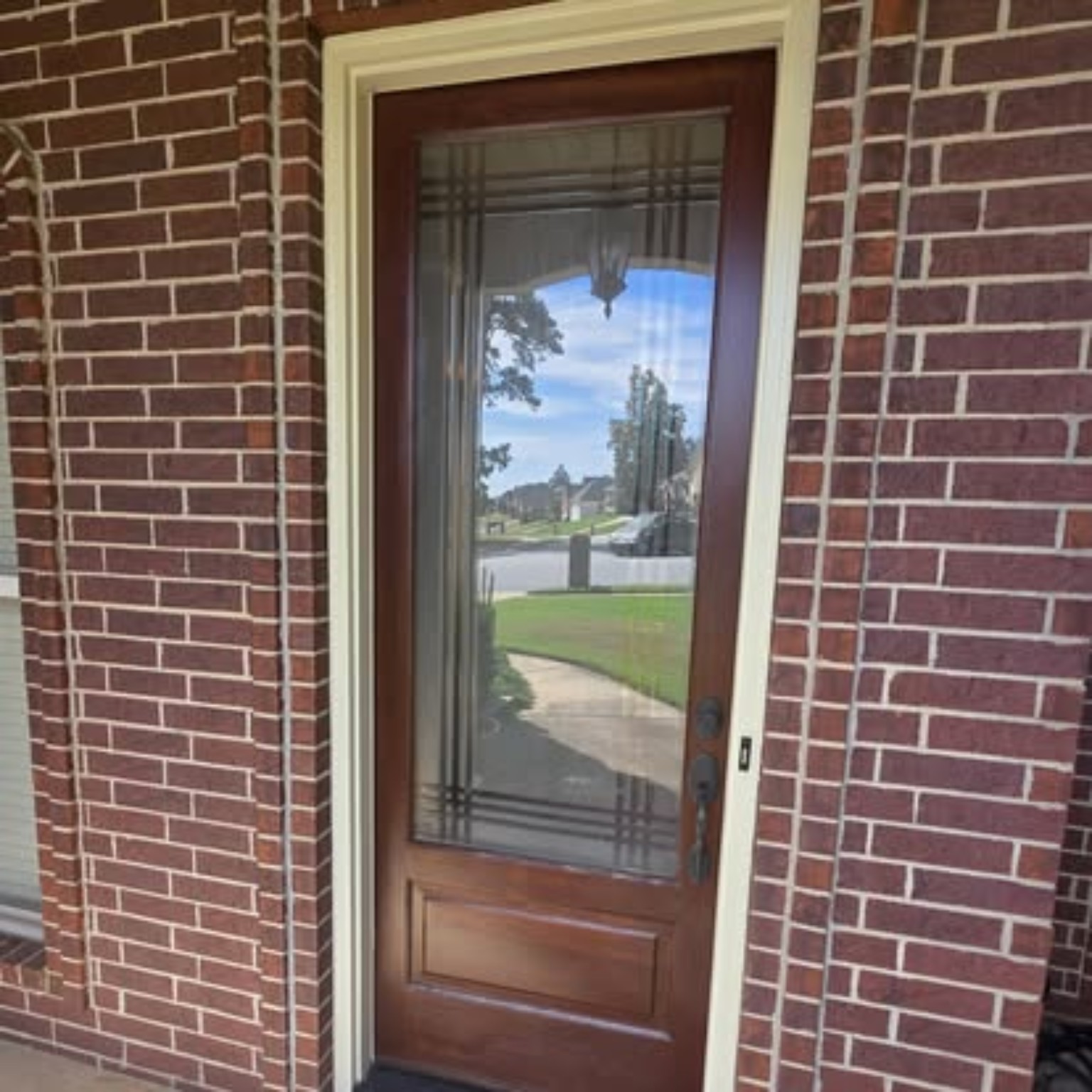 Front entry door after restoration and rich wood stain