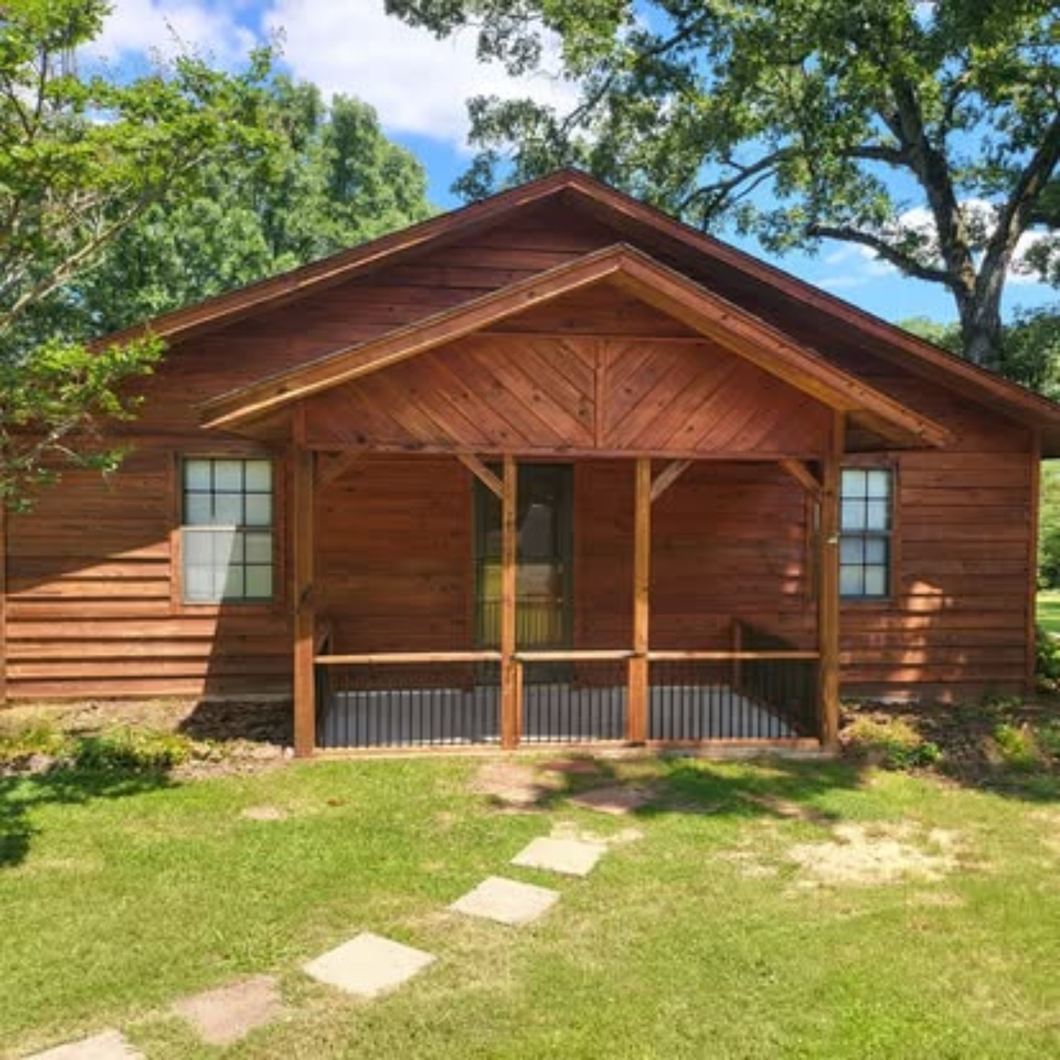 Wood house exterior and porch after full restoration and warm cedar staining