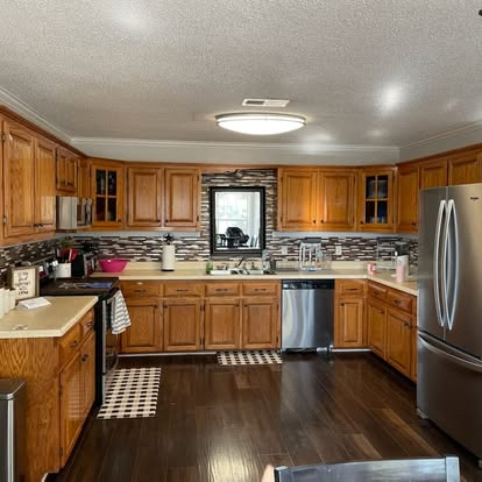 Full kitchen before transformation with golden oak cabinets and laminate counters