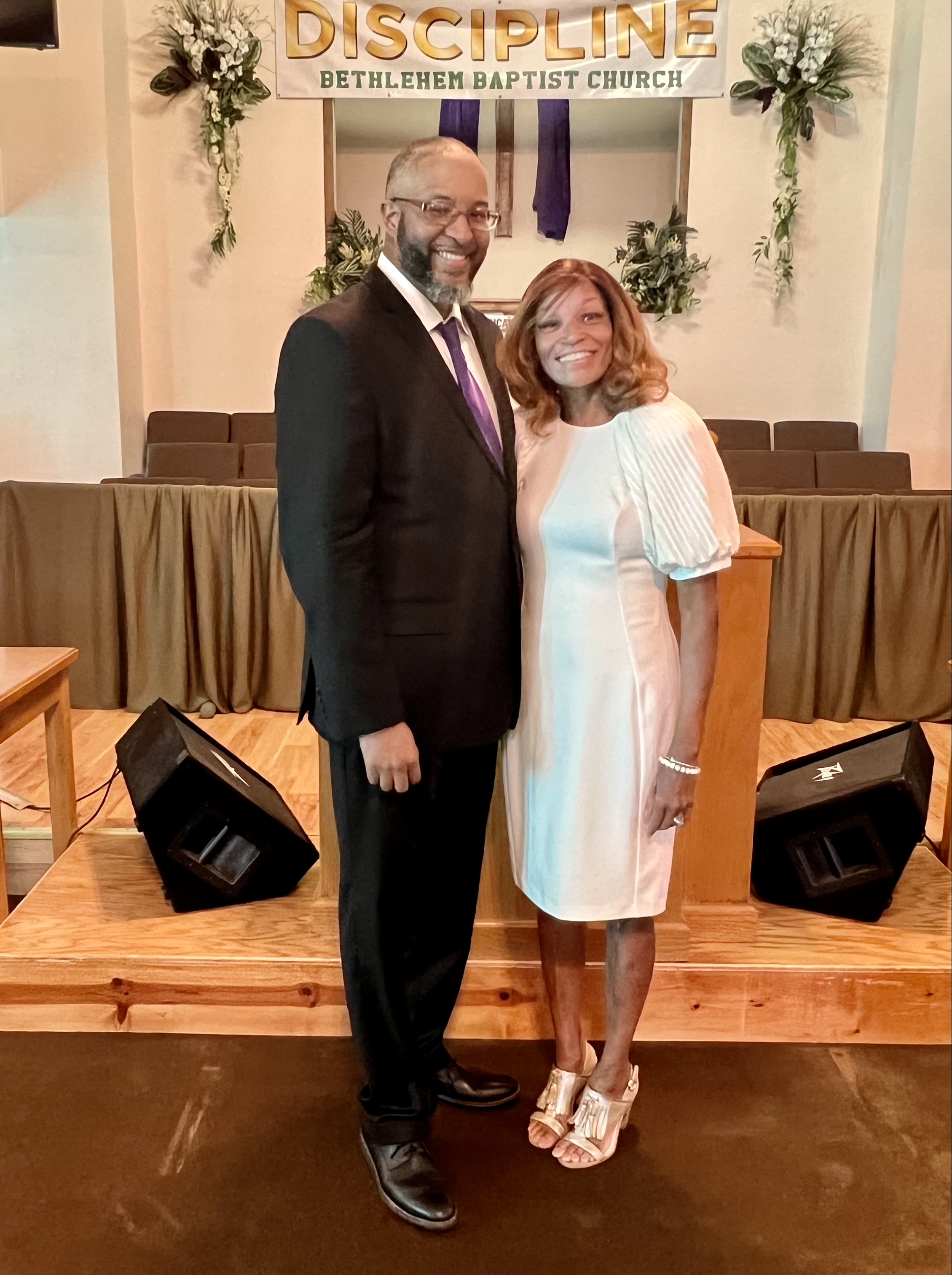 Pastor Delmus L. Gillis II and First Lady Stephanie Gillis in the sanctuary before the altar