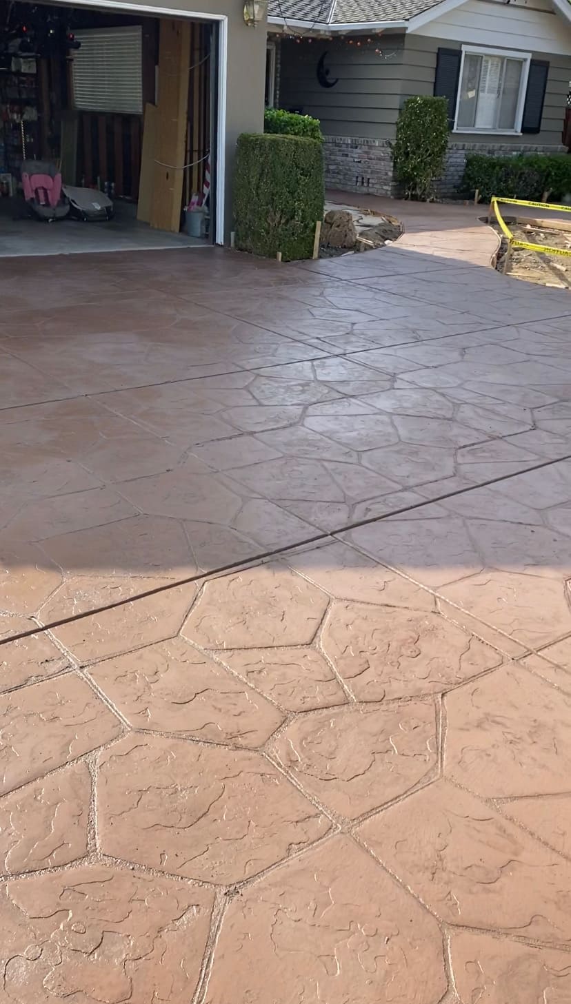 Decorative stamped concrete driveway and front walkway with geometric flagstone pattern