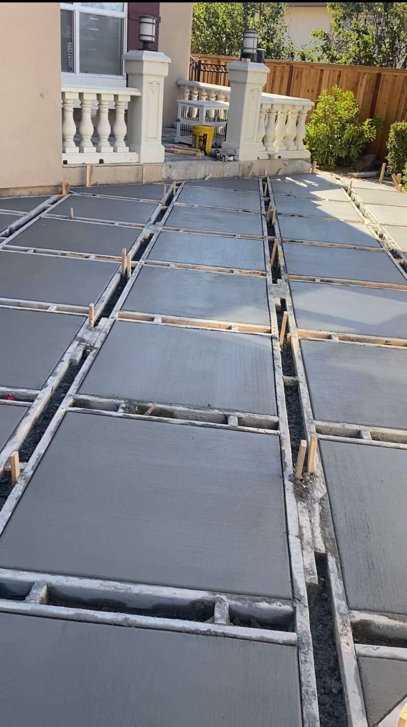 Modern geometric square concrete slab grid installation with precision formwork for residential entrance