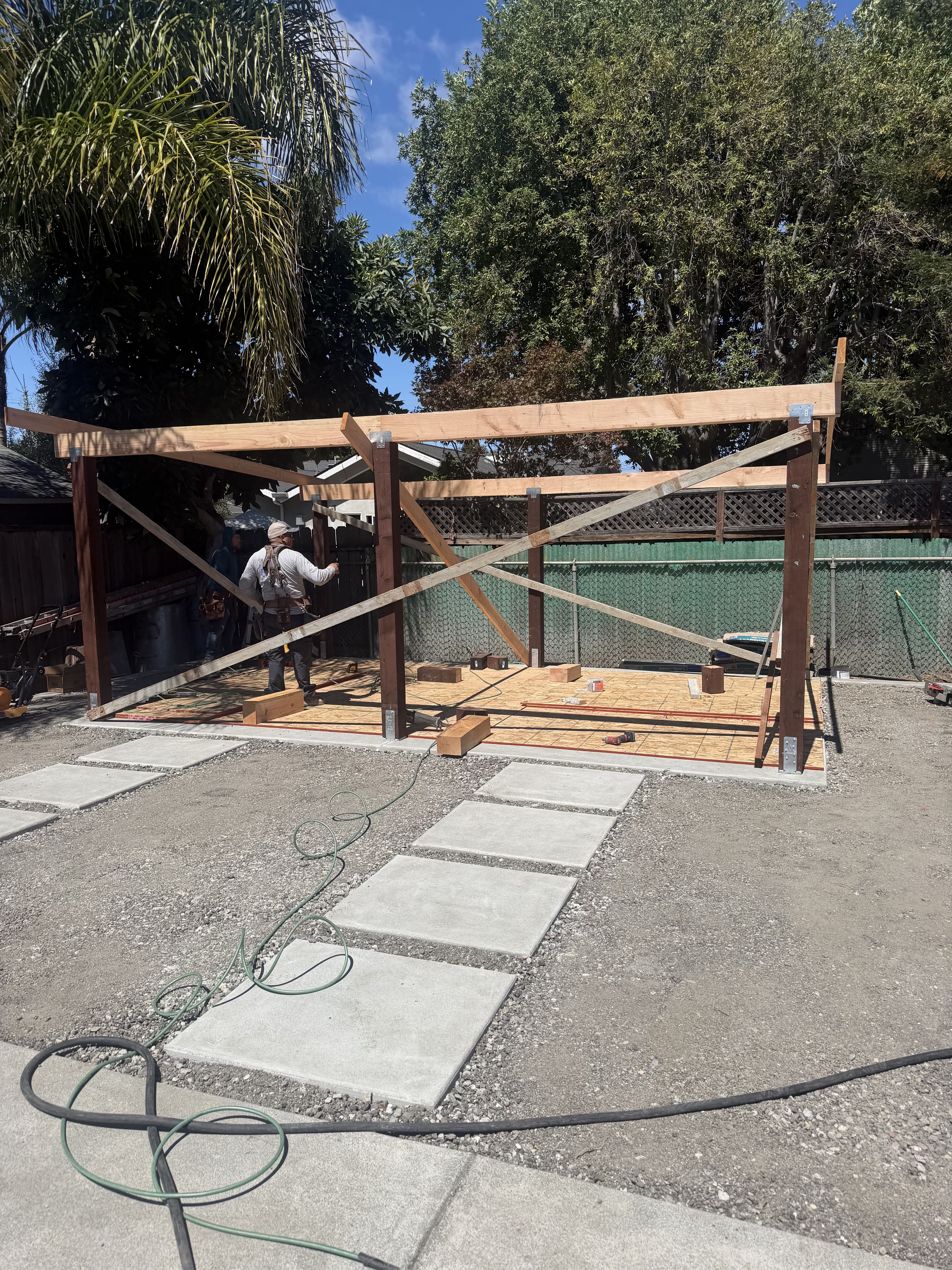 Custom wooden structure framing with concrete foundation pavers and walkway steps