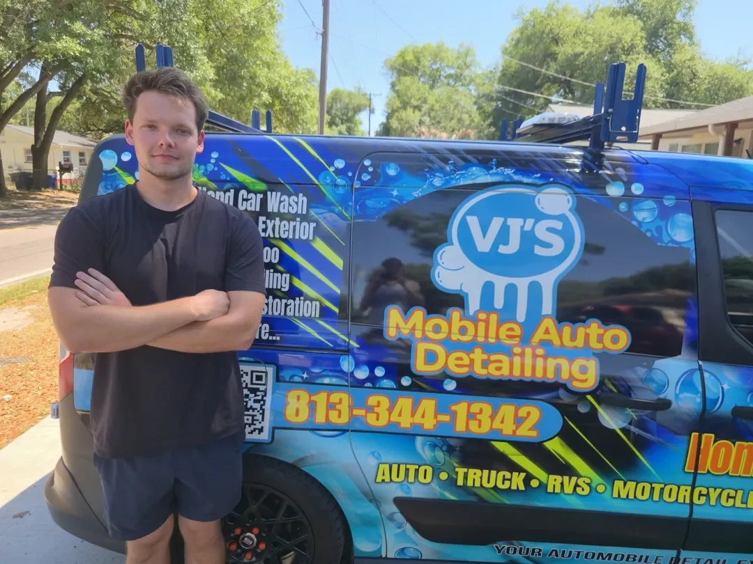 Victor standing by the official VJ's Mobile Auto Detailing van
