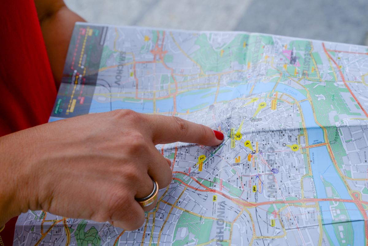 local business owner pointing to target city on regional map for local customer acquisition