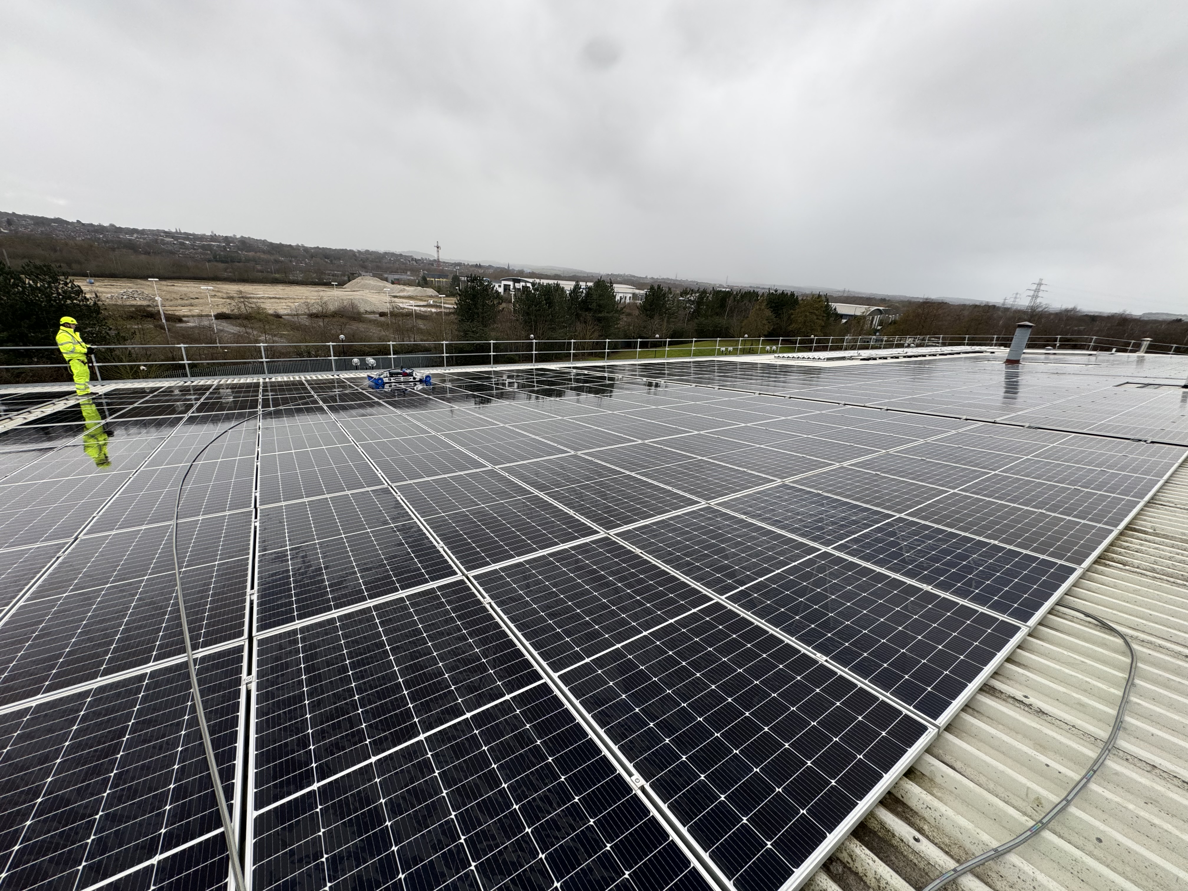 EcoServ operative and cleaning robot on a commercial rooftop solar array