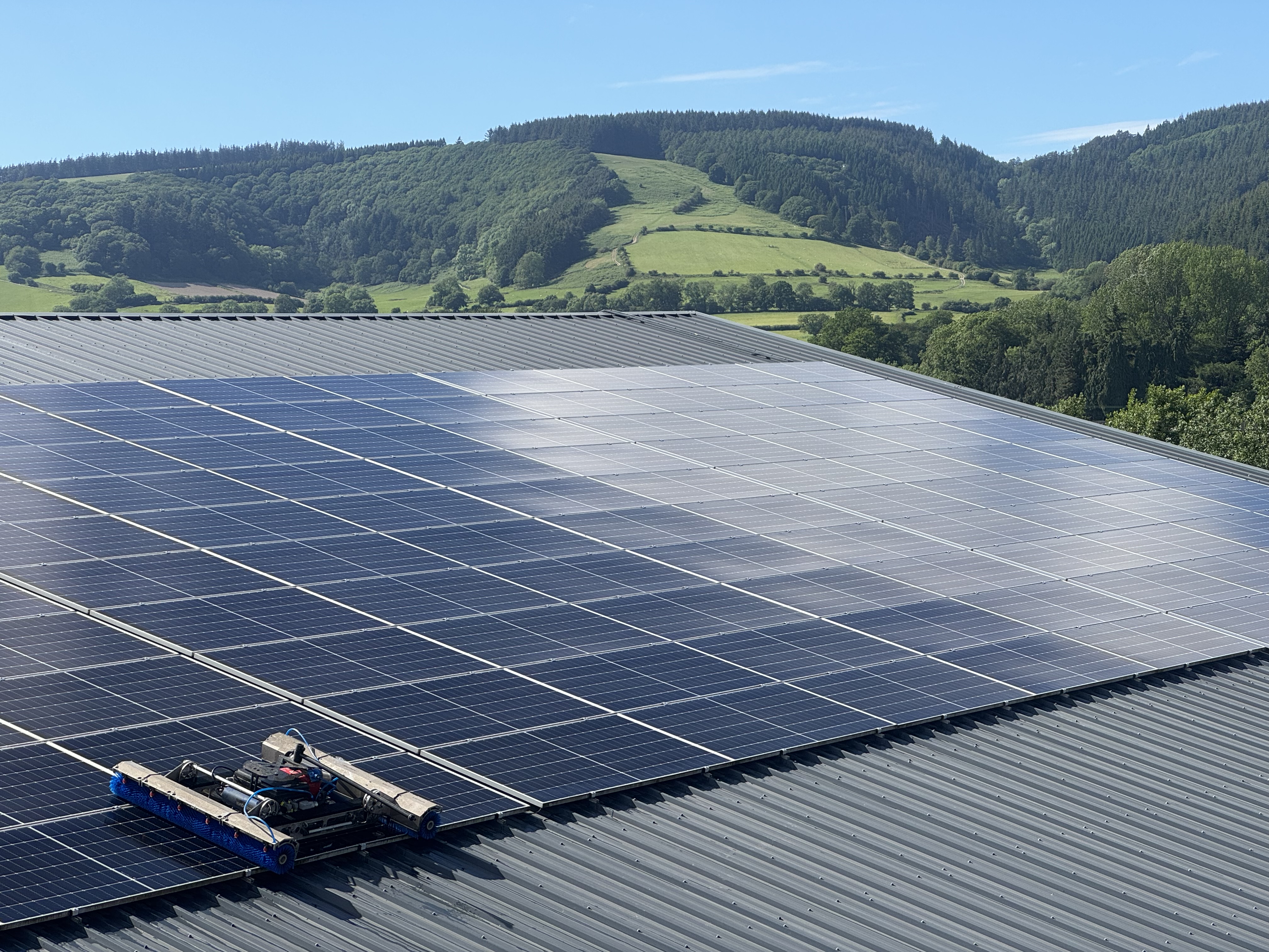 EcoServ cleaning robot on a commercial rooftop solar array.
