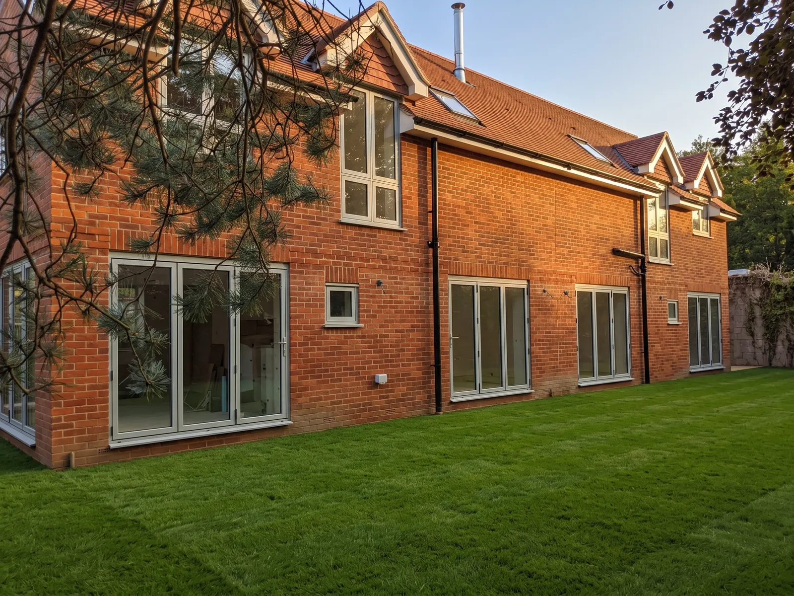 Copse Cottages, a pair of new-build semi-detached brick cottages in the New Forest