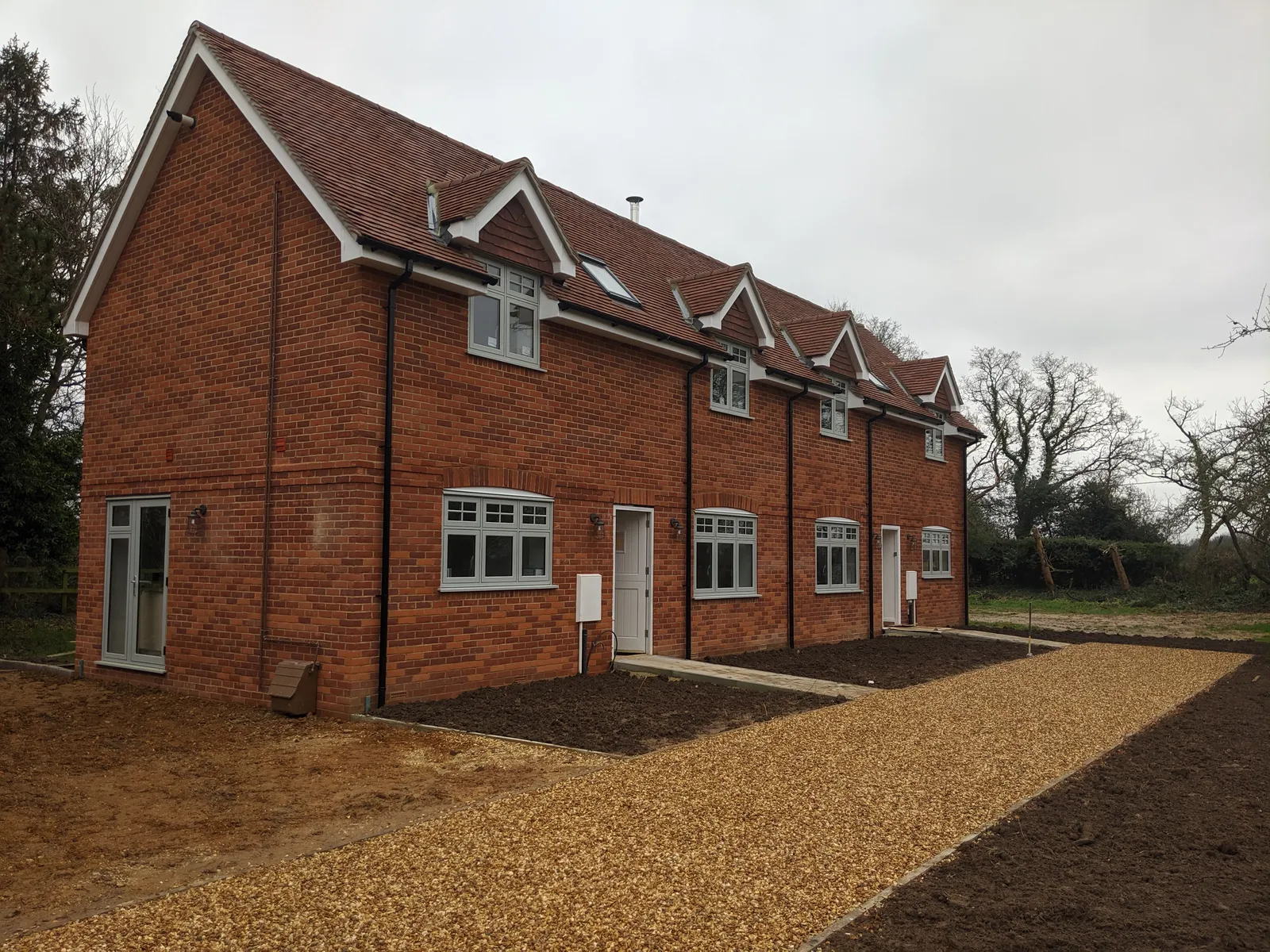 Copse Cottages, new-build brick cottages in the New Forest — the completed cottages from the approach