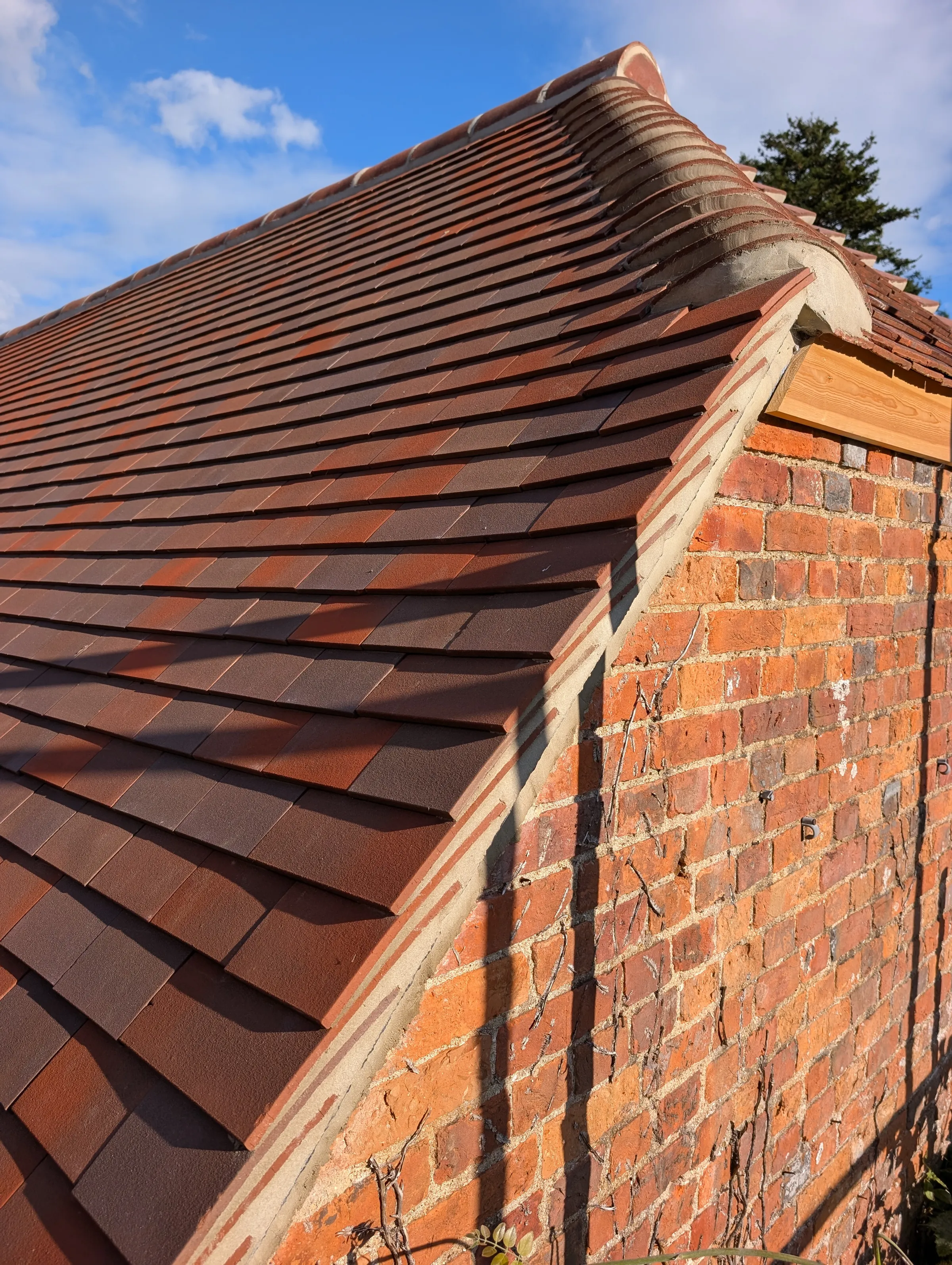 The Mill, a traditional brick and oak-beam building undergoing roof refurbishment and conversion