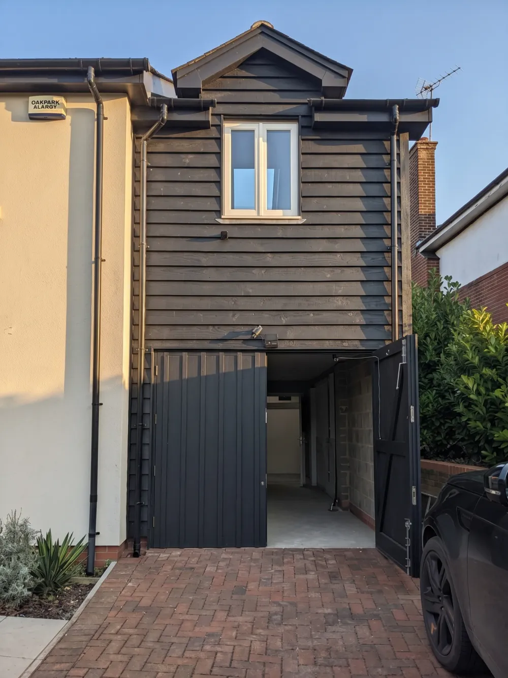 Peppercorn, a black timber-clad extension to a house in Sway, completed exterior