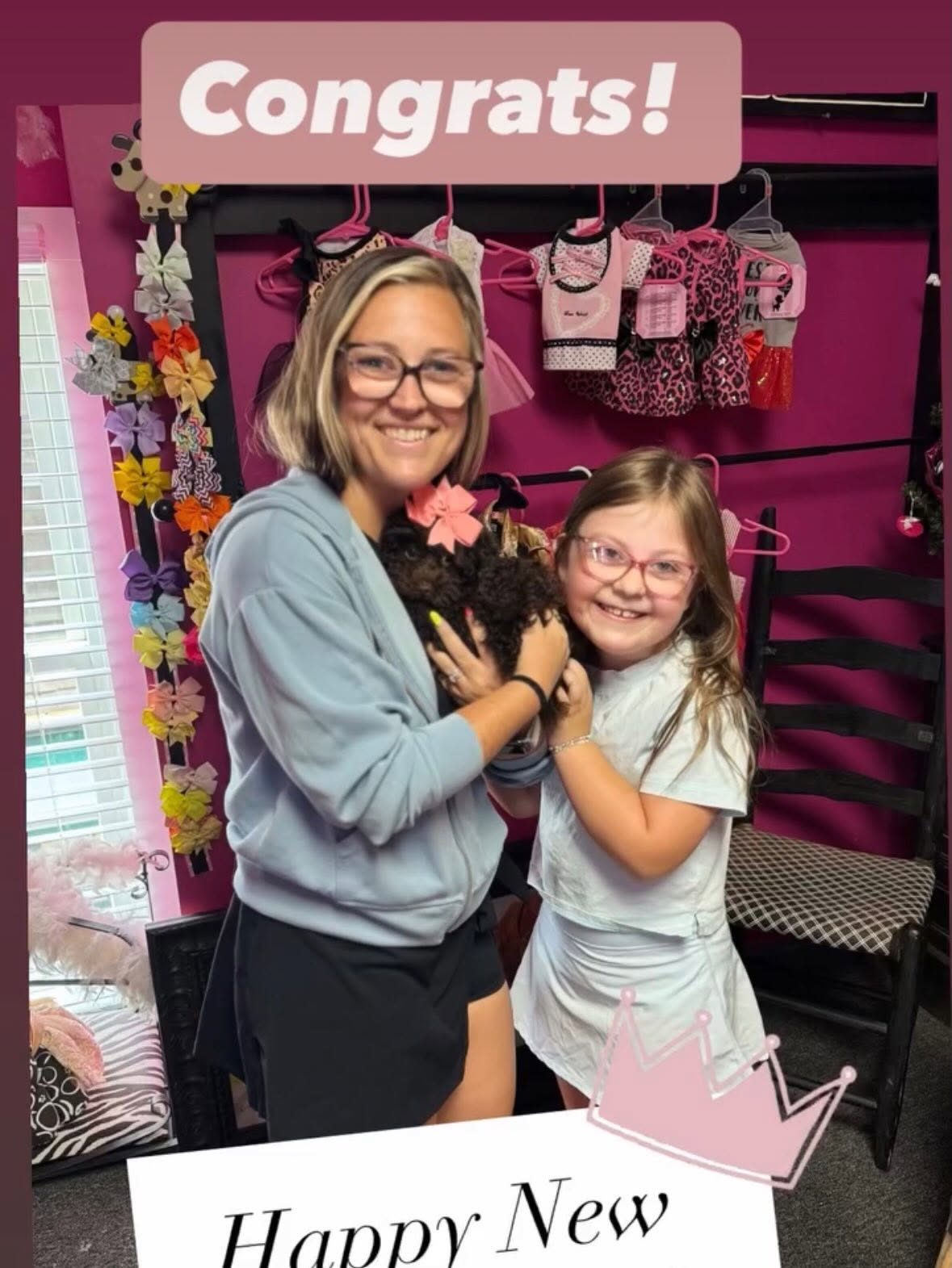 Mother and daughter celebrating with their new puppy in the boutique