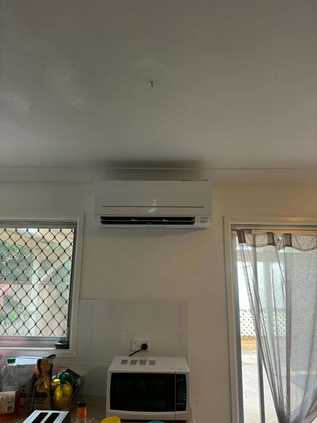Split system air conditioner installation in dining kitchen area by Total Blackout Electrical
