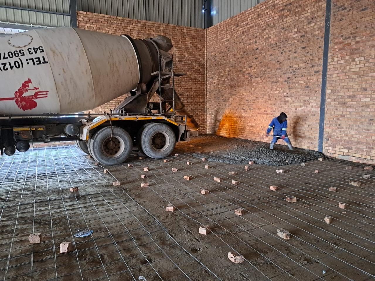 Concrete truck pouring onto reinforcing mesh at Titan Jet Africa