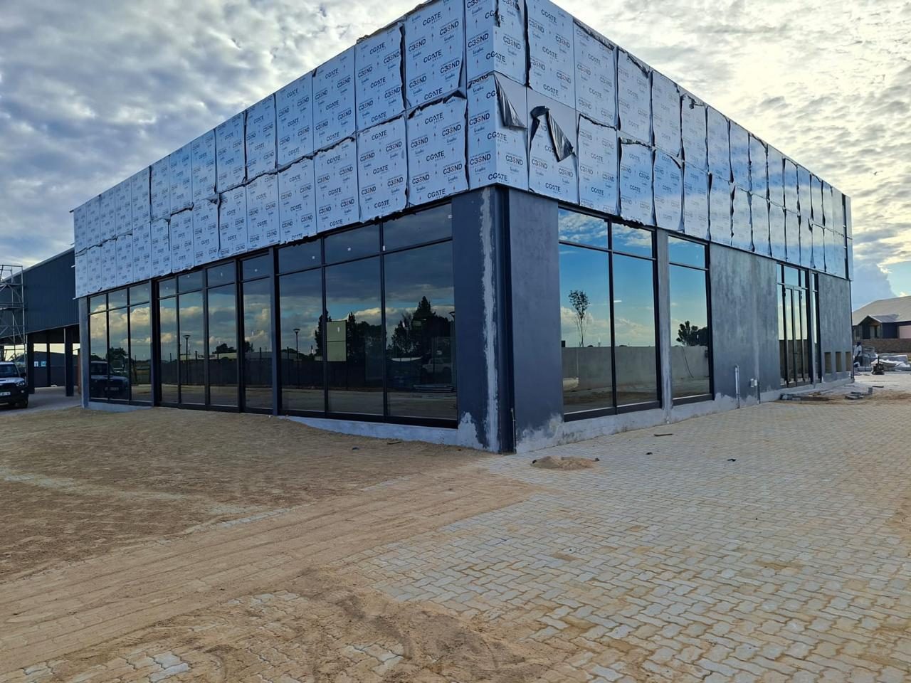 Completed dealership with a glass curtain facade
