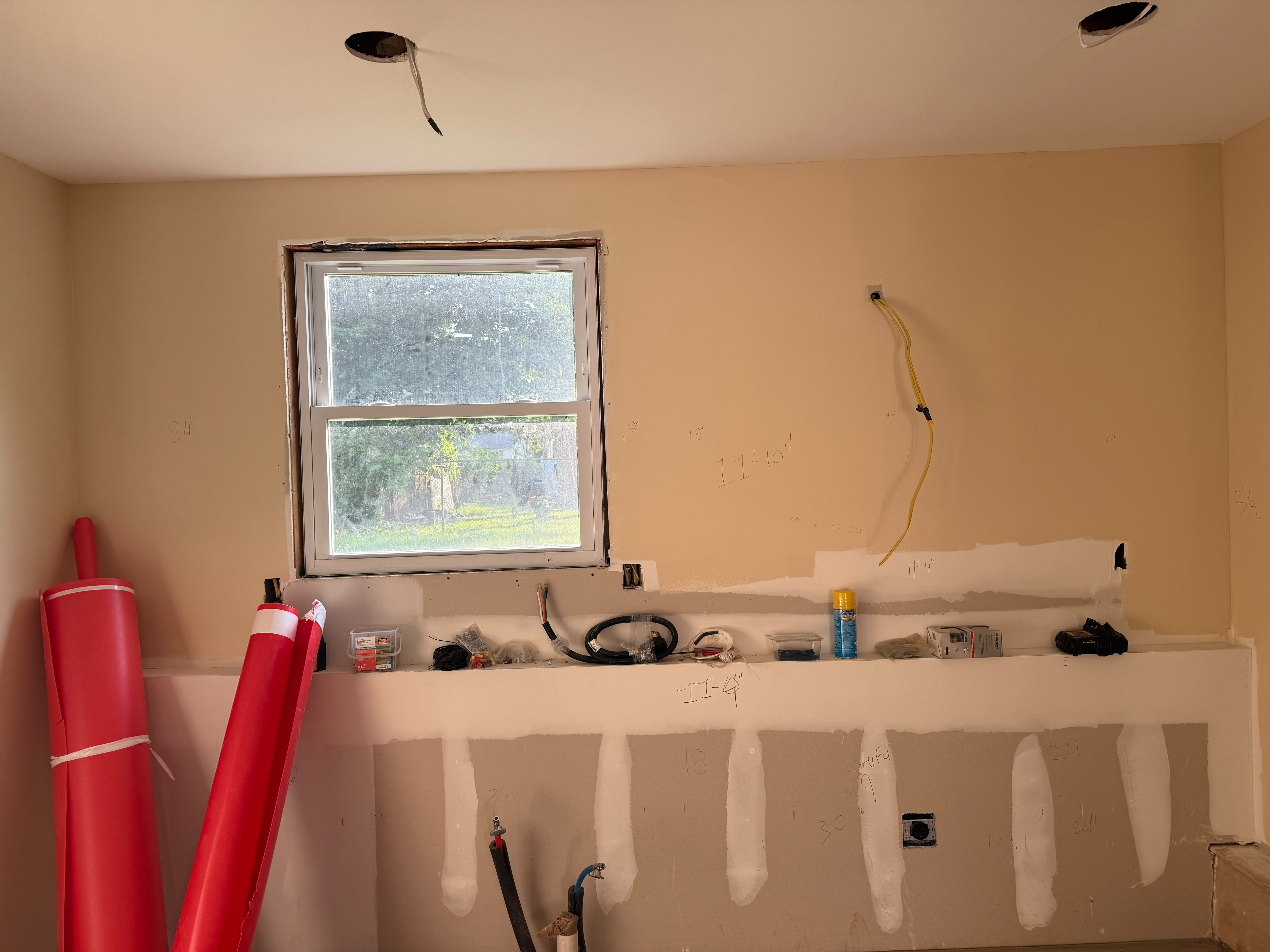 Kitchen remodeling in-progress layout dimensions, taped drywall, replacement window, and dedicated appliance wiring by LQJ General Construction in Central Islip NY