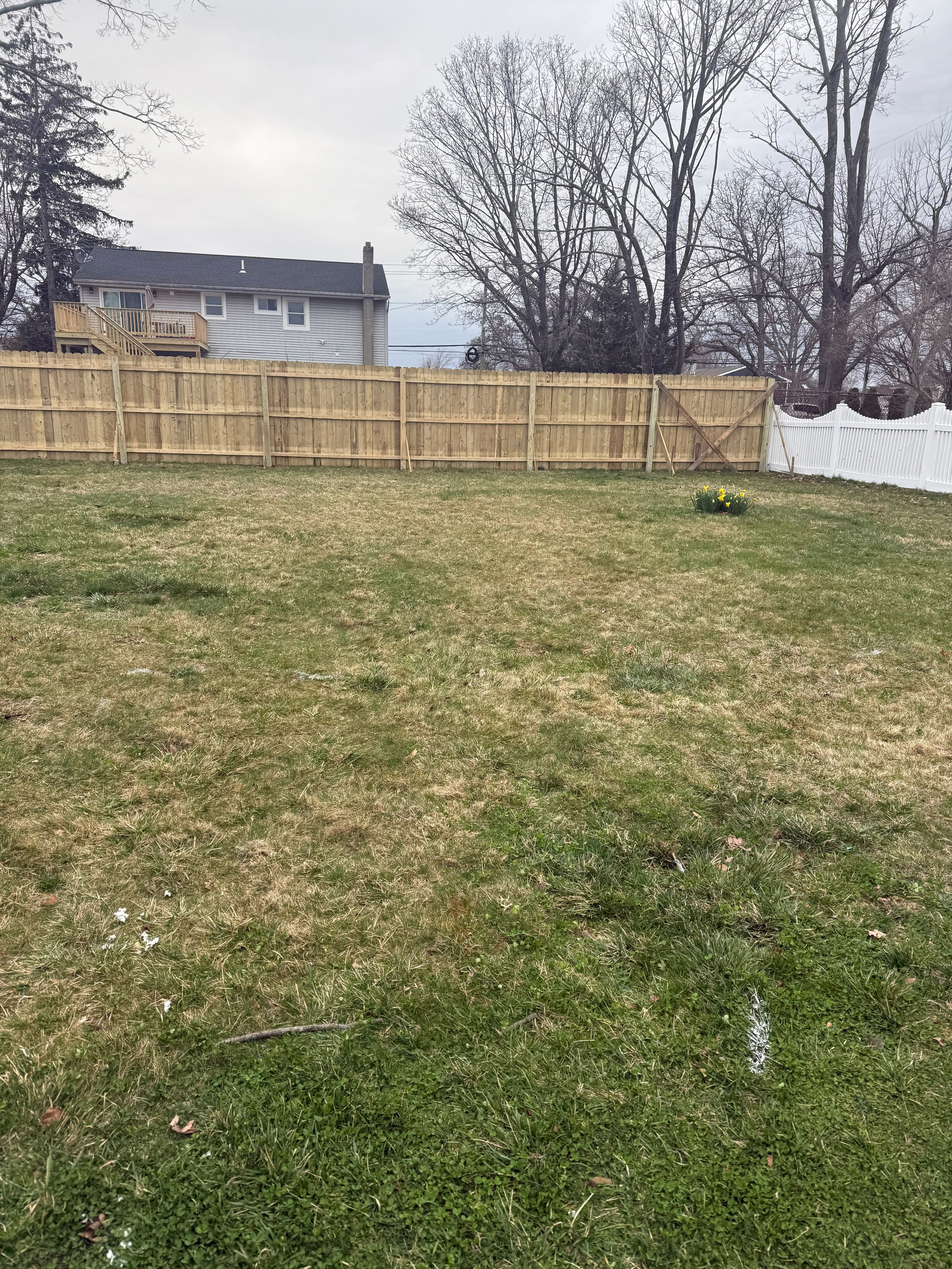 Backyard perimeter wood privacy fence installation and diagonal gate cross-bracing by LQJ General Construction in Commack NY