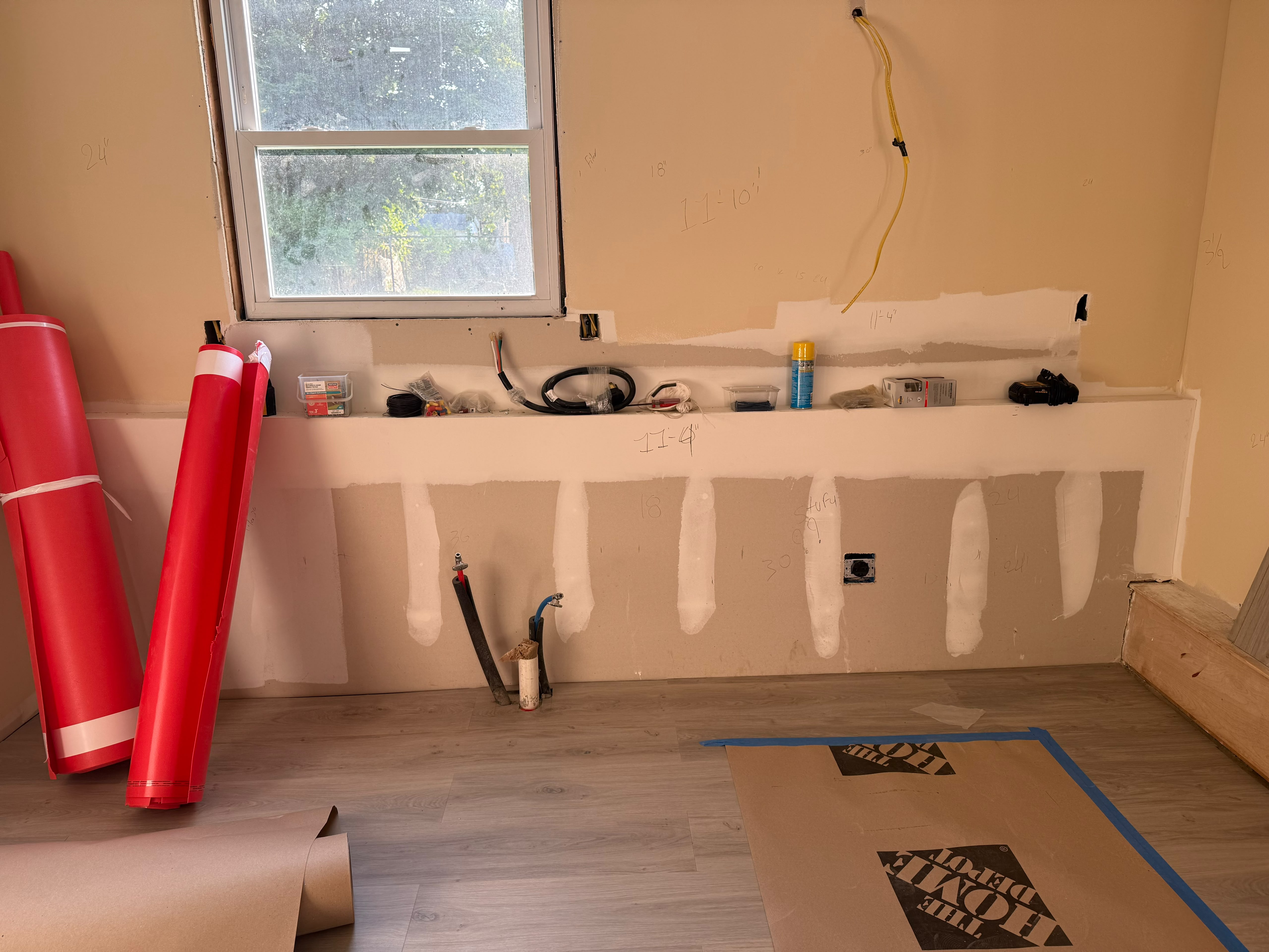 Kitchen wall layout measurements, rough-in plumbing, and wood plank flooring prep by LQJ General Construction in Central Islip NY