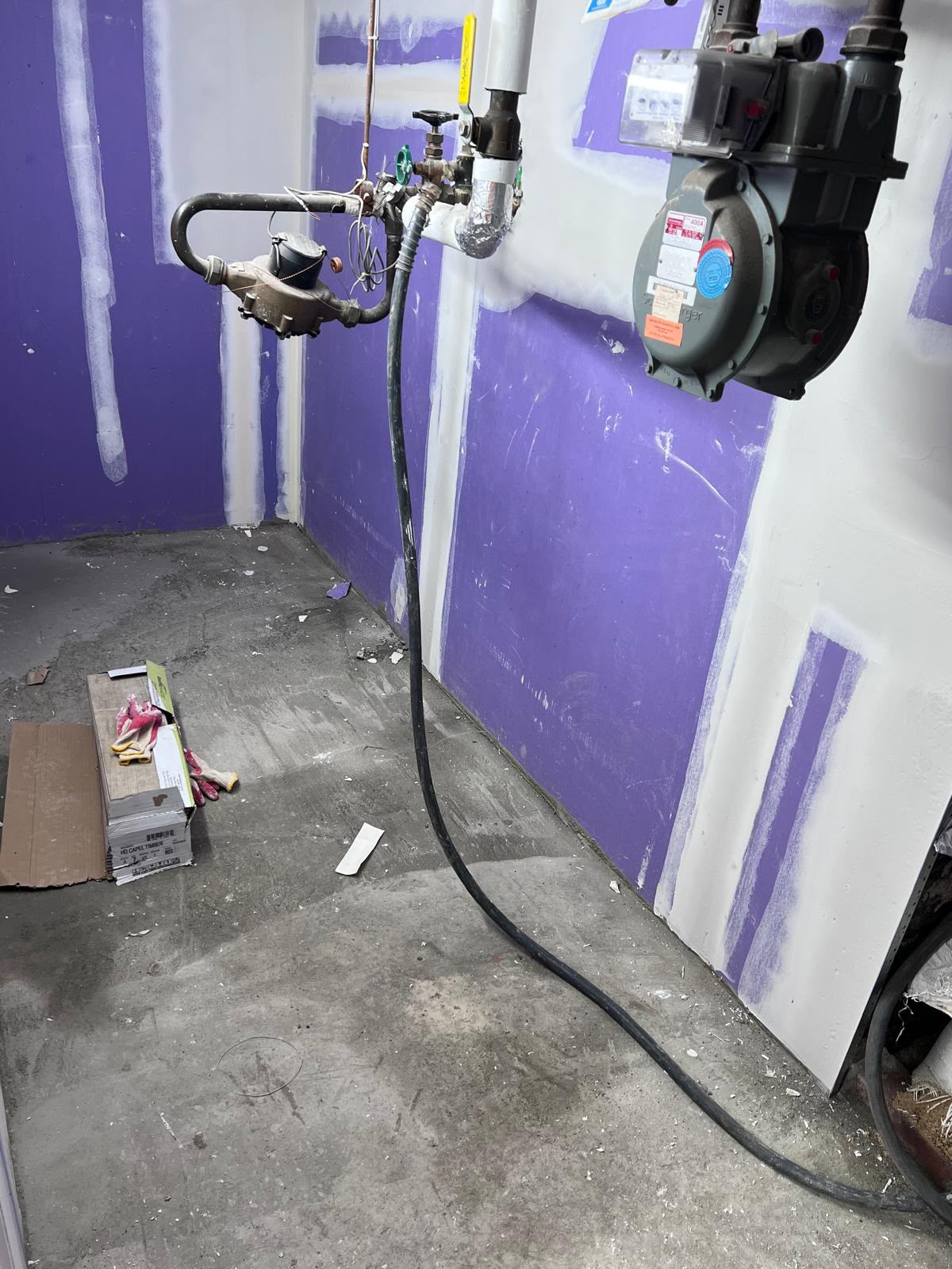 Moisture-resistant drywall installation and concrete subfloor preparation in basement utility room by LQJ General Construction