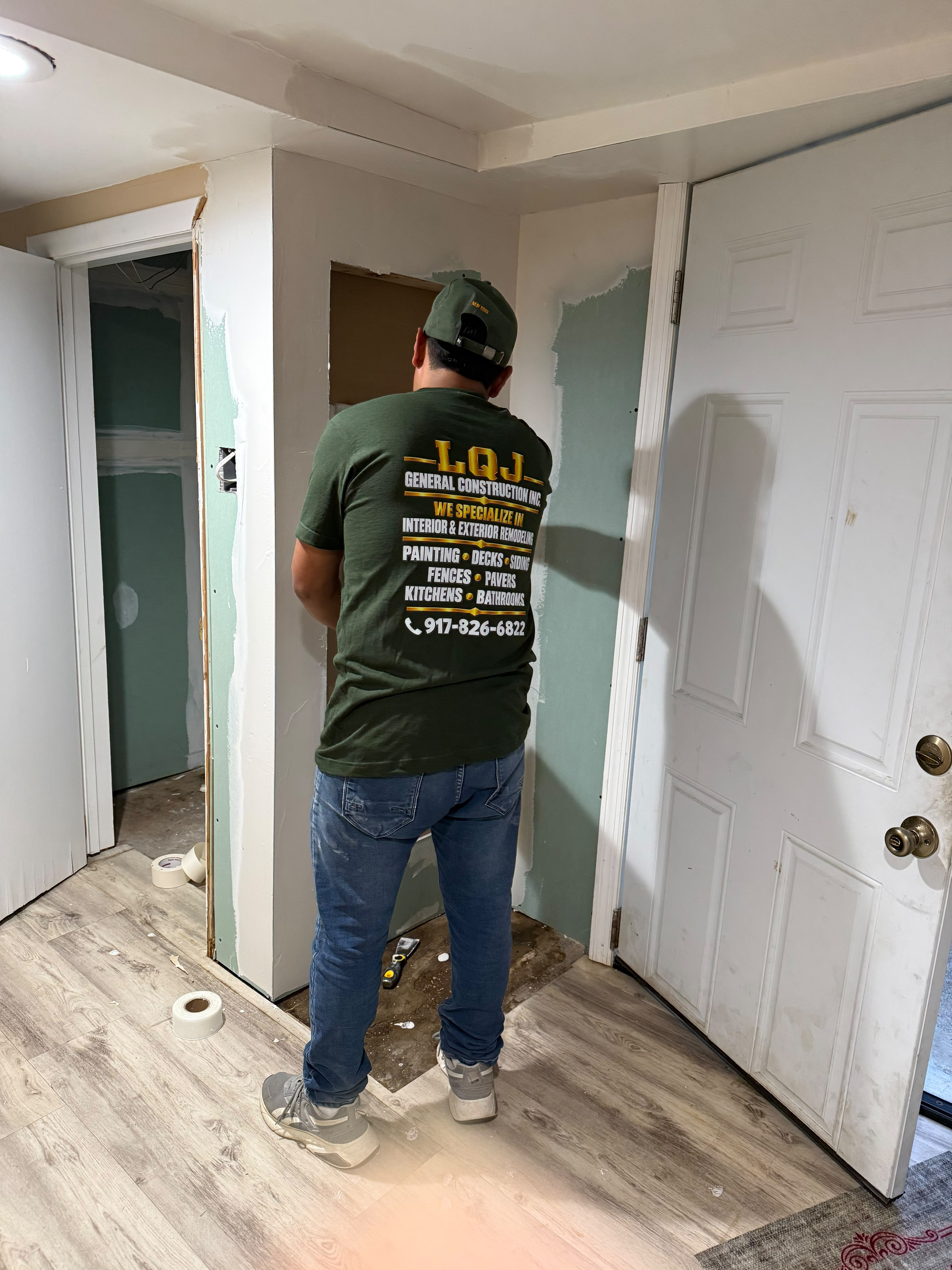 LQJ General Construction team member inspecting recessed drywall niche and corner beads in Ronkonkoma NY