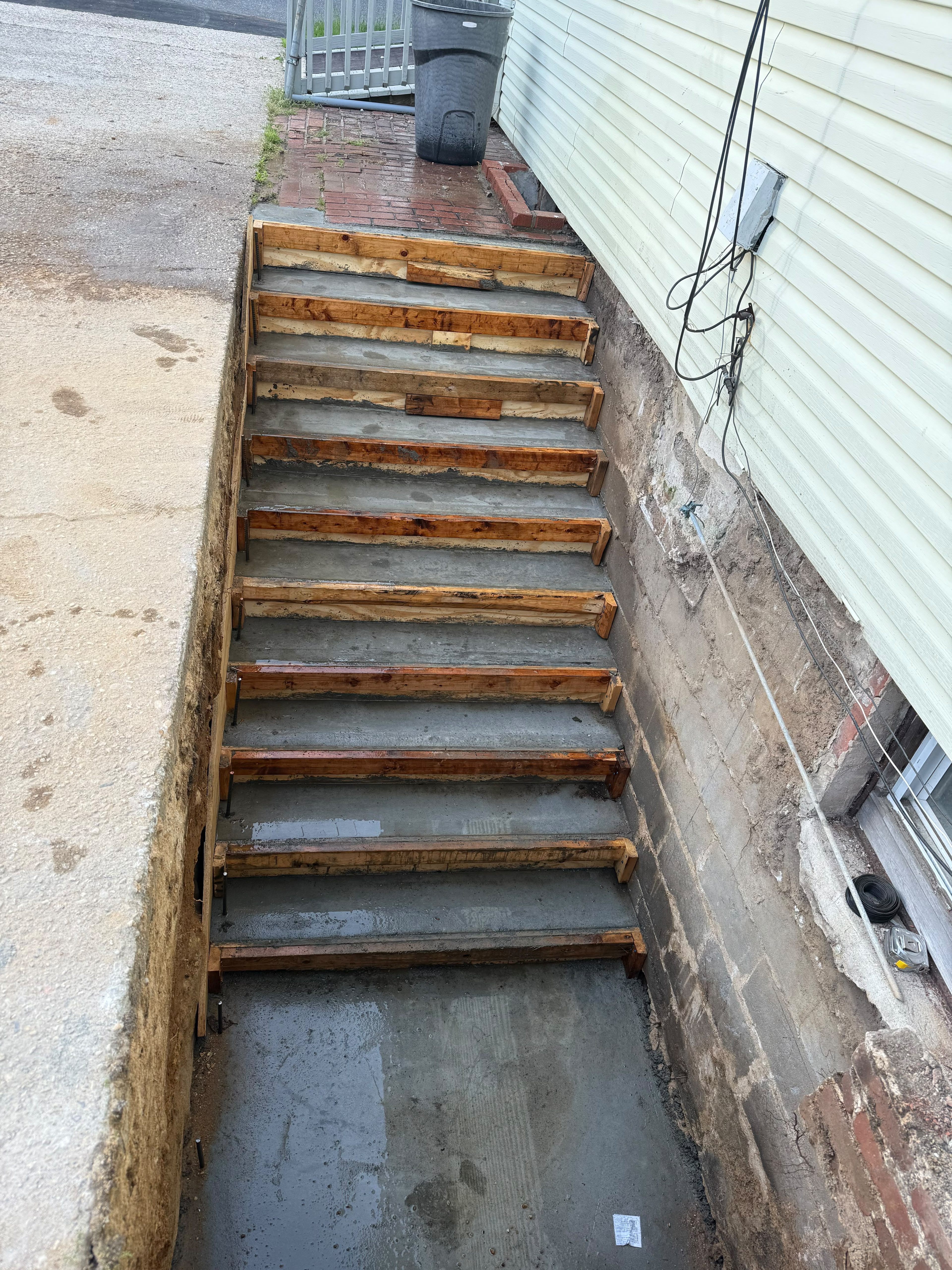 Exterior concrete basement entrance stairs and heavy timber formwork by LQJ General Construction in Central Islip NY