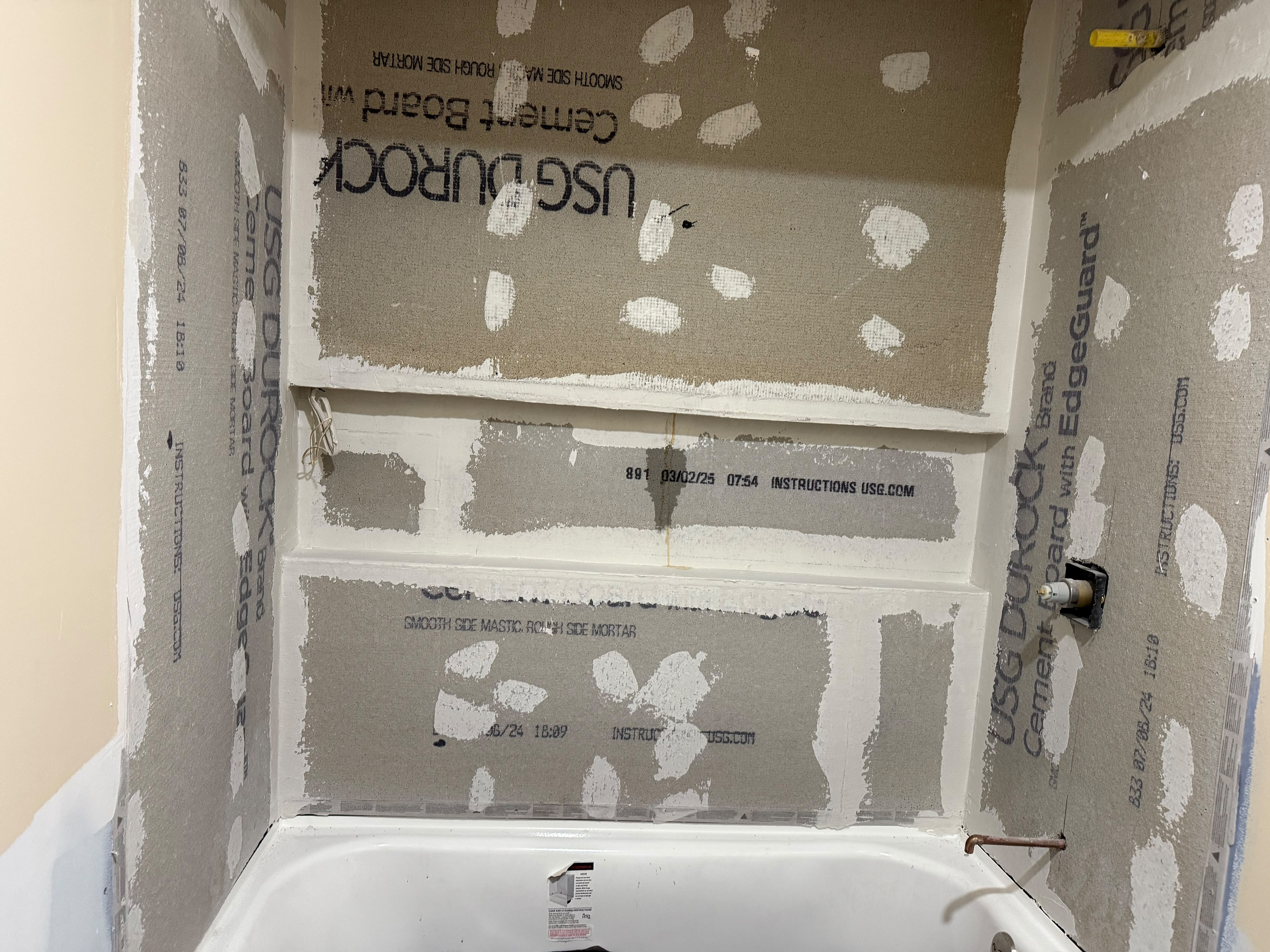 USG Durock cement backer board installation and recessed shampoo niche rough-in over bathtub by LQJ General Construction in Smithtown NY