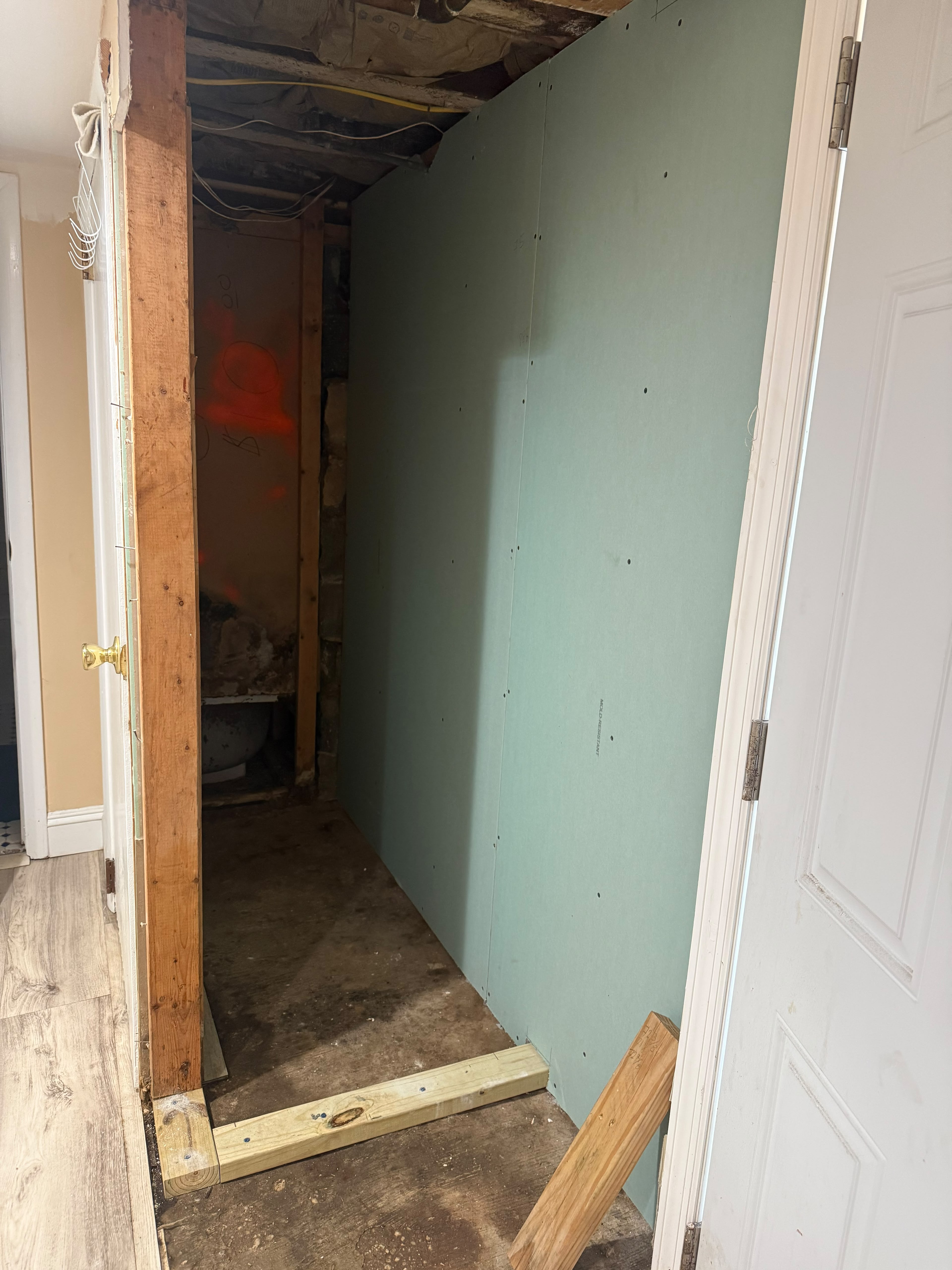 Mold-resistant green board drywall sheet installation on basement partition wall by LQJ General Construction in Bay Shore NY