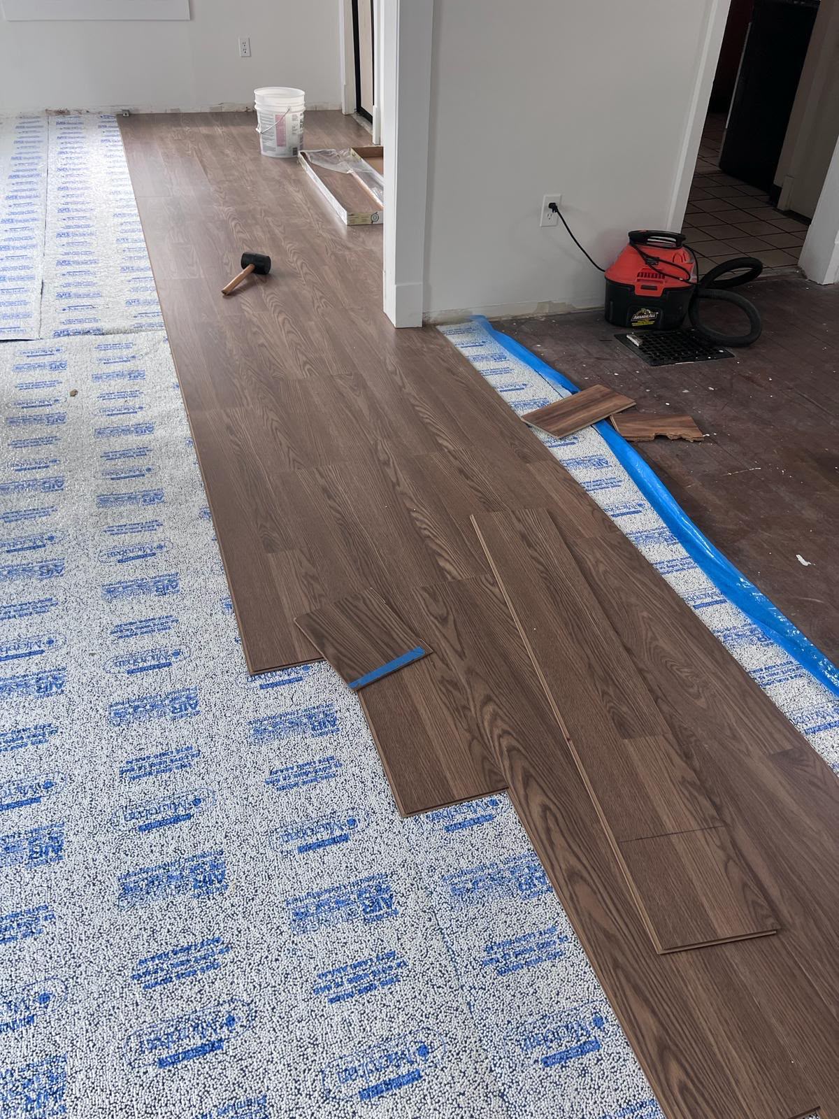 Installation of wide-plank wood-look flooring over acoustic thermal underlayment by LQJ General Construction in Commack NY