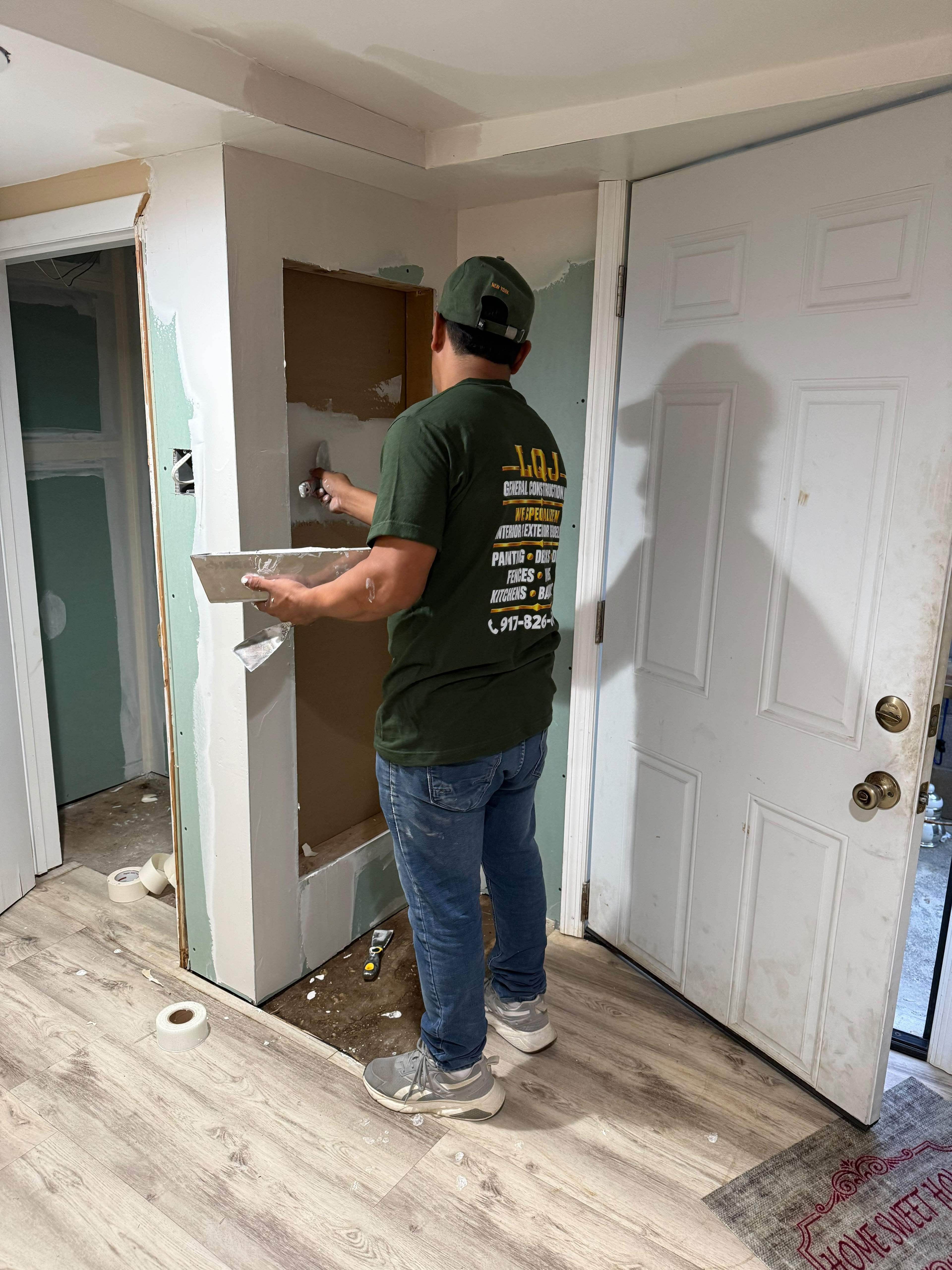 LQJ General Construction craftsman applying joint compound and skimming a custom recessed wall niche in Ronkonkoma NY