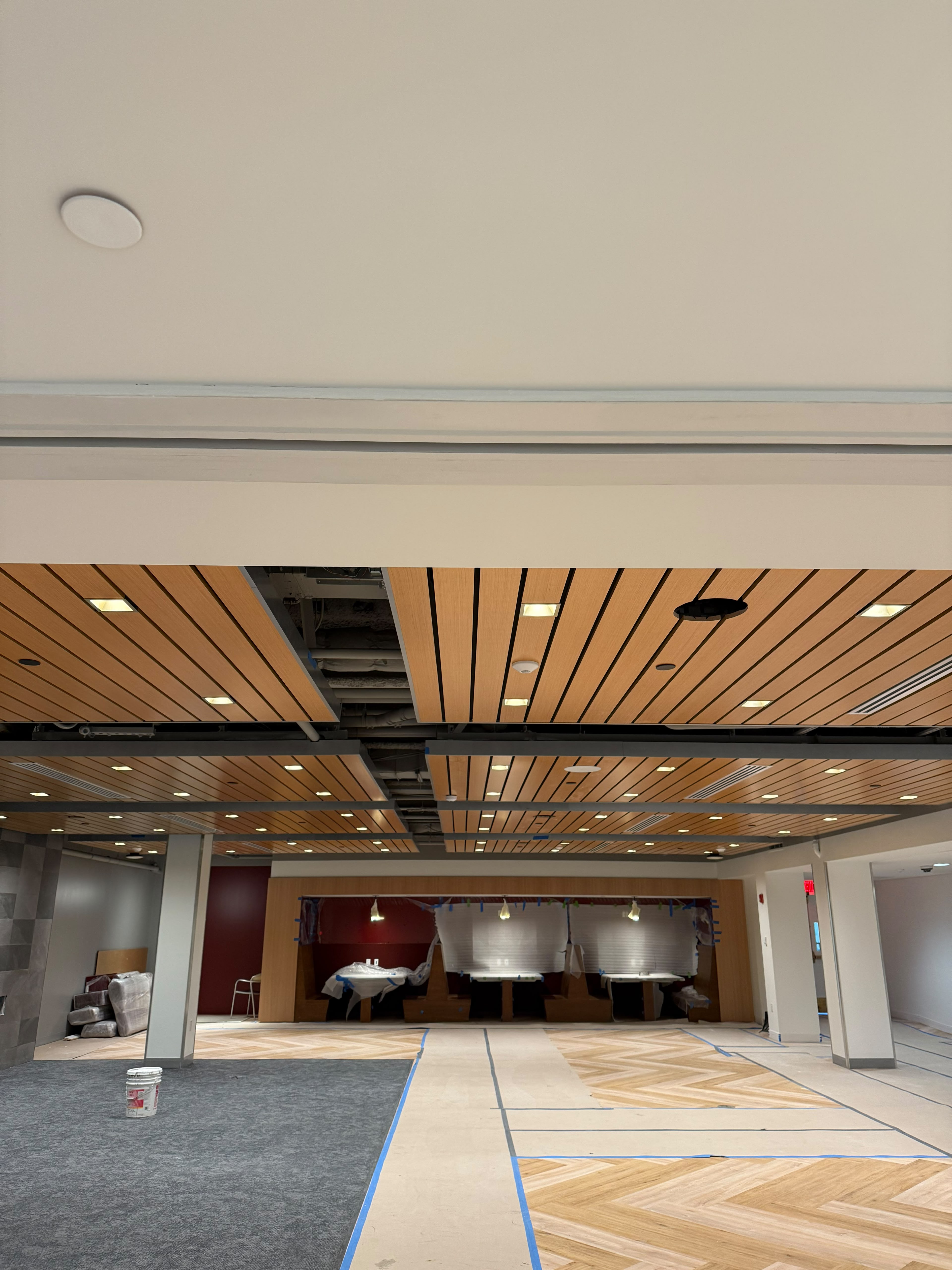 Architectural wood-slat suspended ceiling panels and custom built-in dining booths by LQJ General Construction in Hauppauge NY