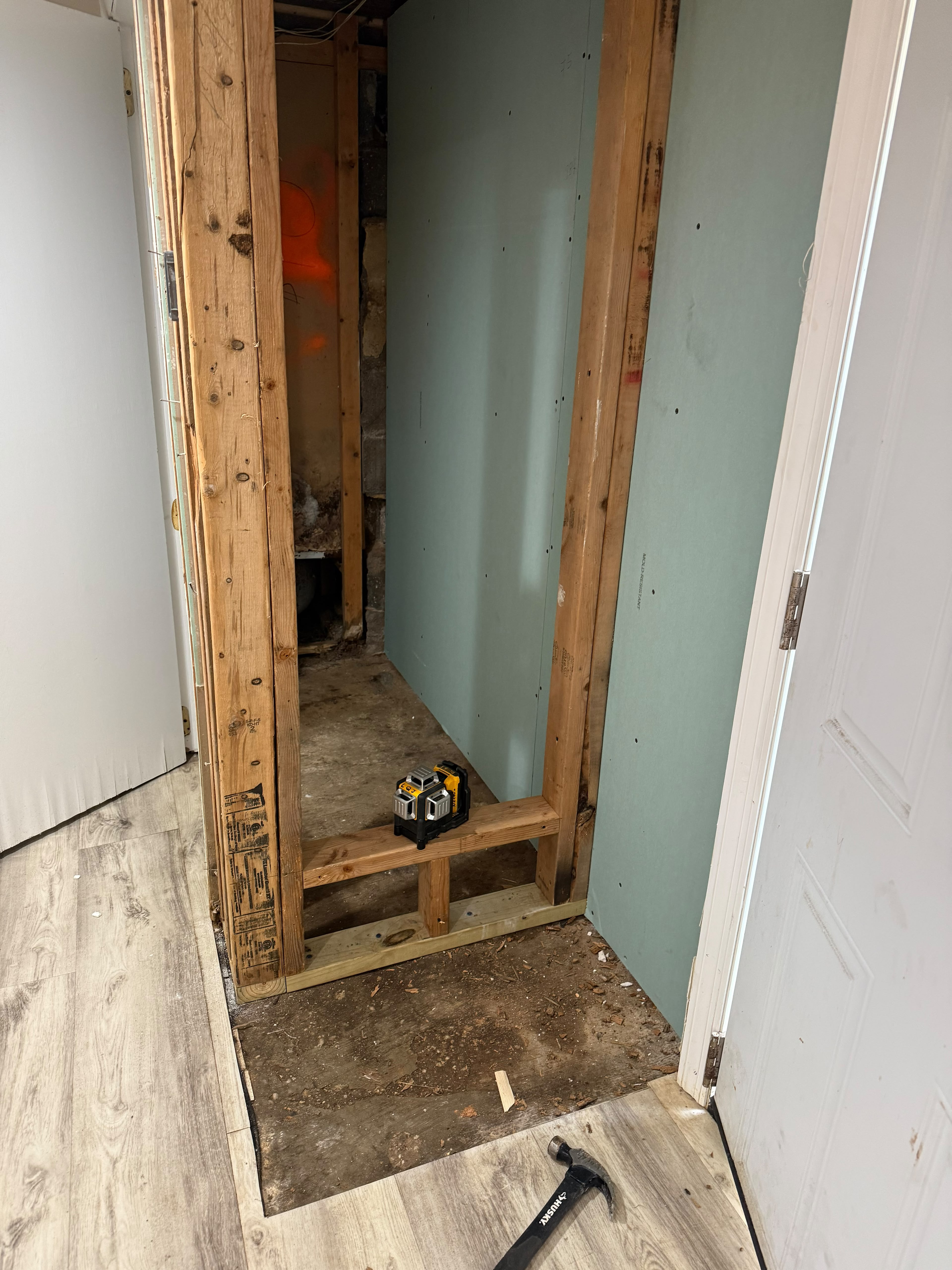 Custom walk-in shower curb framing and moisture-resistant board installation by LQJ General Construction in Hauppauge NY